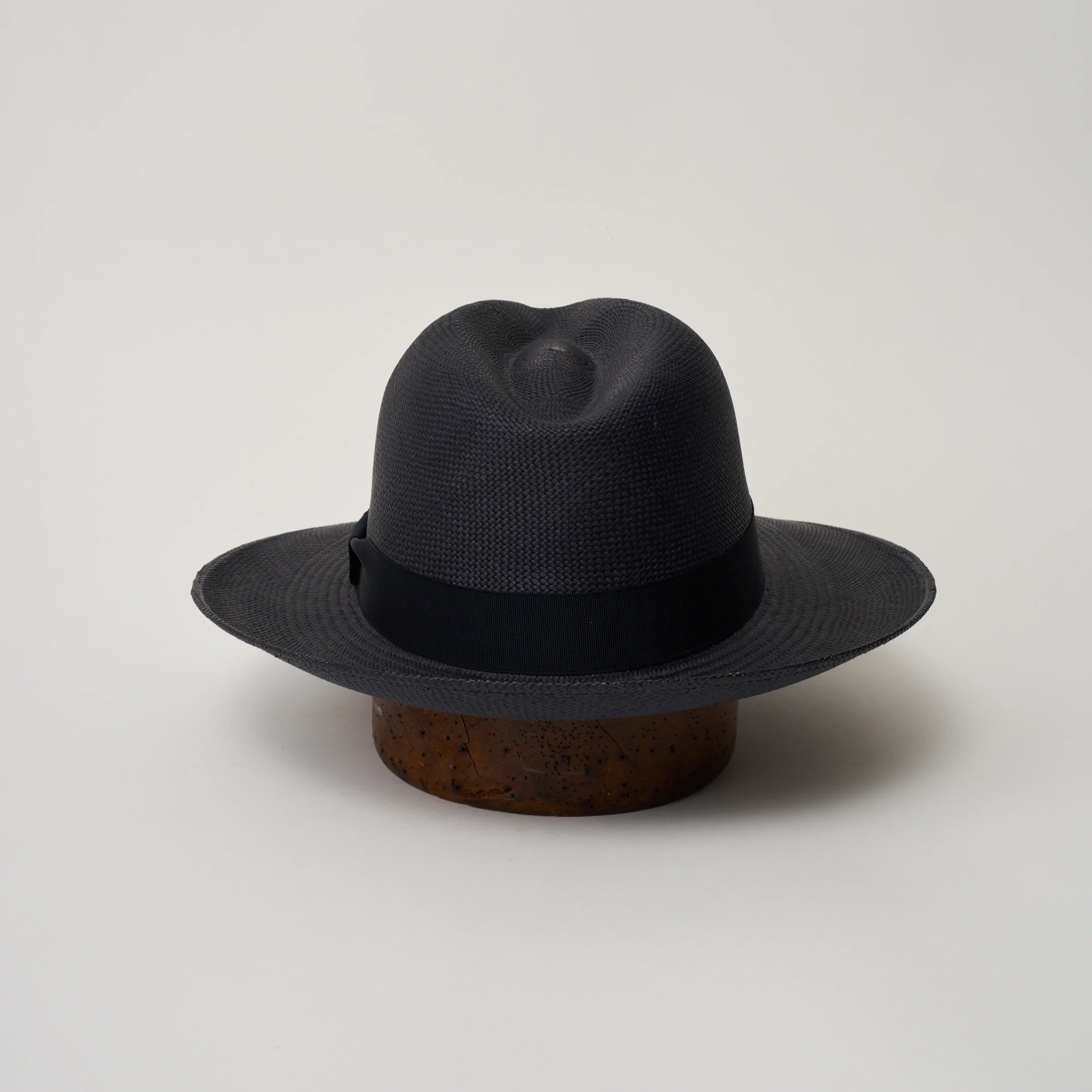Studio image of the Camilo Classic Navy coloured Panama Hat with Marine trim taken from the back, showing the snapback brim.