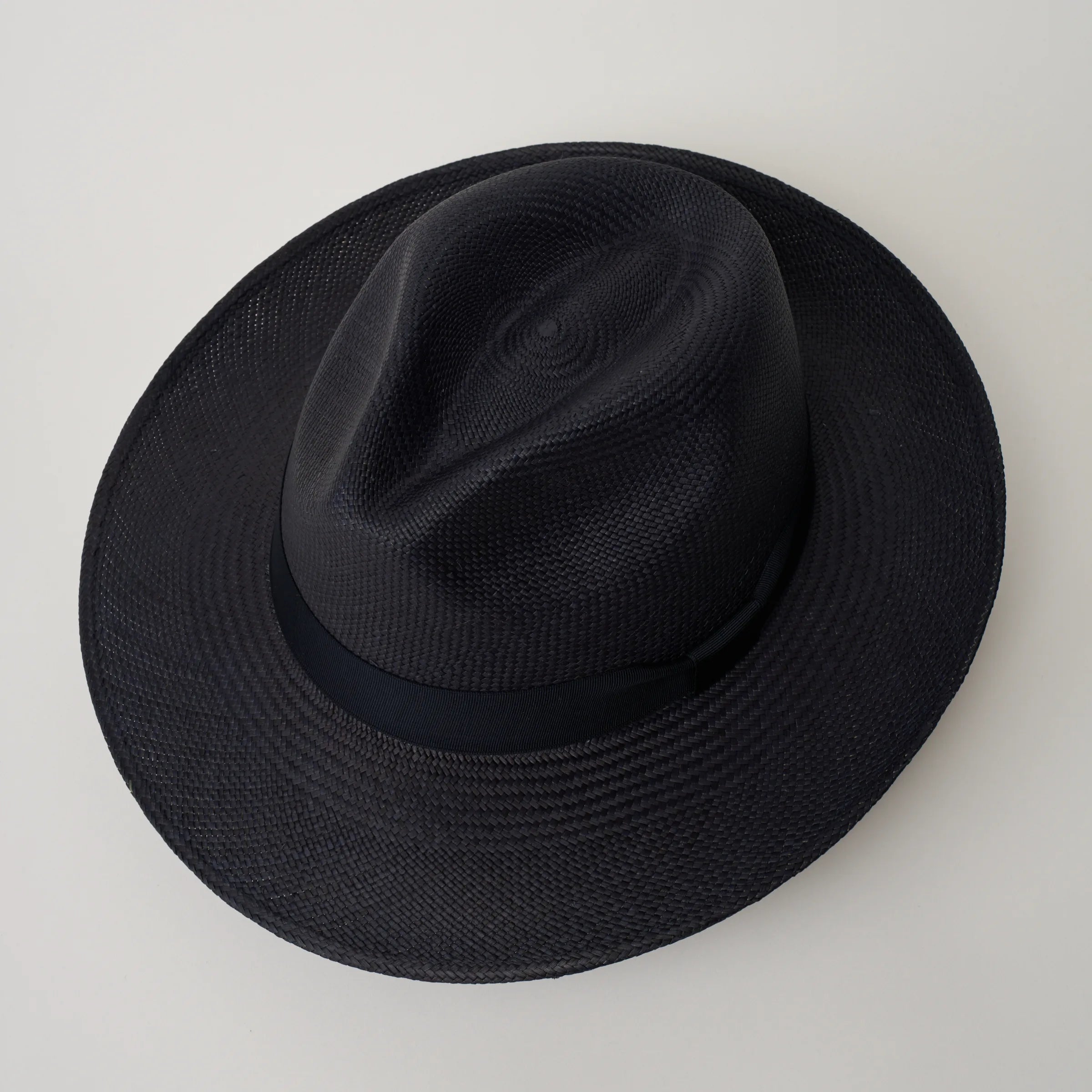 Studio image taken looking down at the Camilo Classic Navy coloured Panama Hat with Marine trim, showing the crown shape and crease.