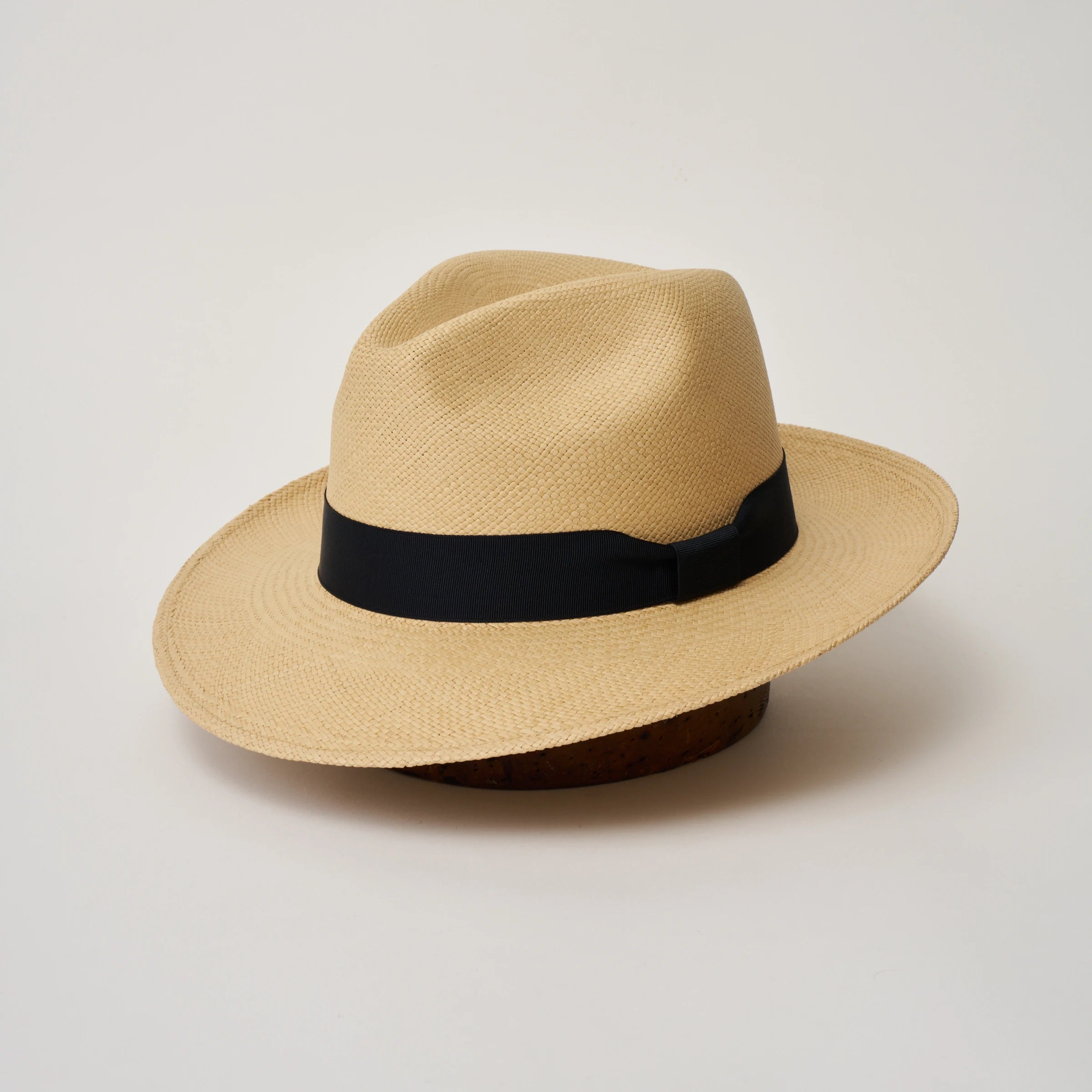 Studio image, angle view of the Camilo Classic Sand coloured Panama Hat with Marine trim, showing the overall hat shape.