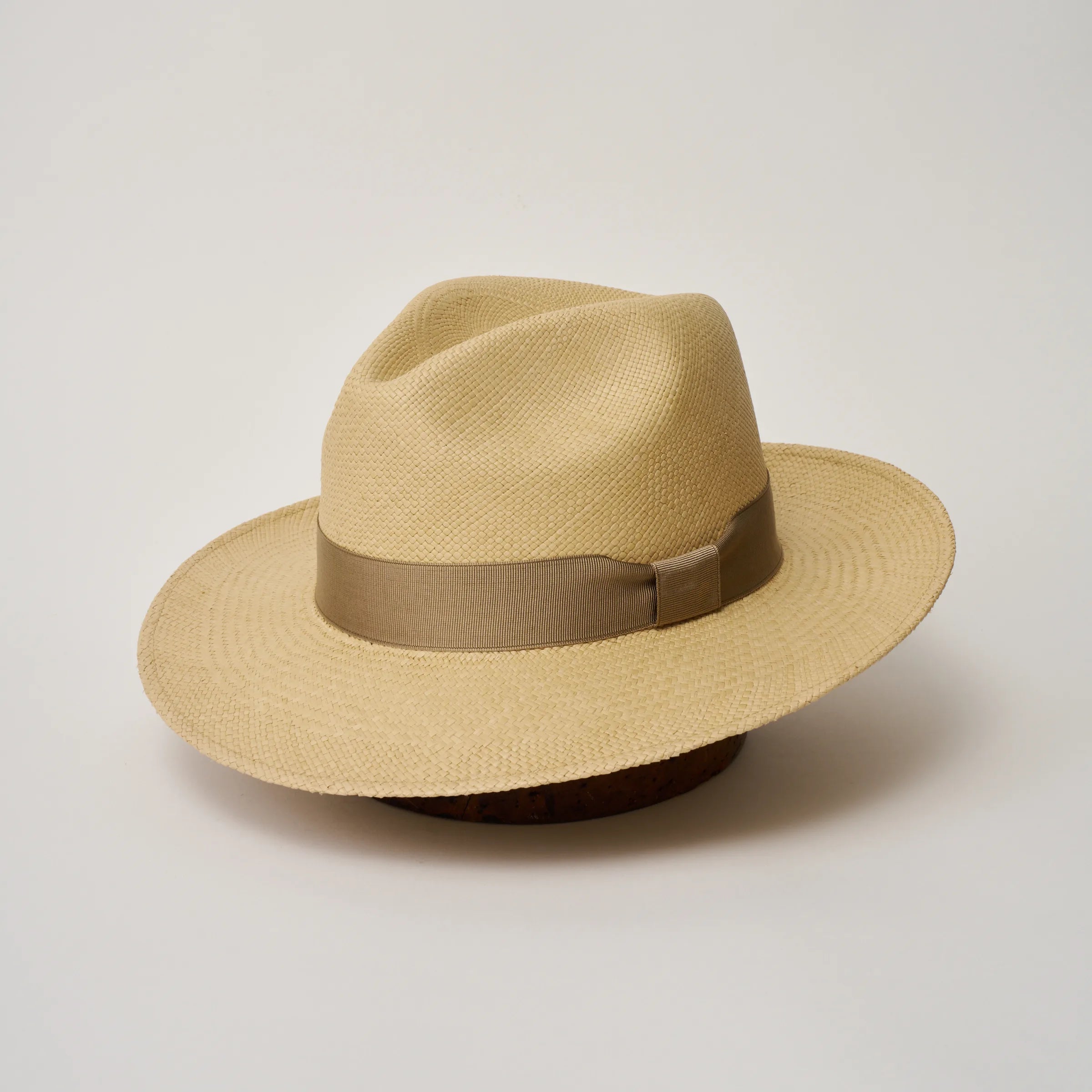 Studio image, angled view of the Camilo Classic Sand coloured Panama Hat with Taupe trim, showing the overall hat shape.