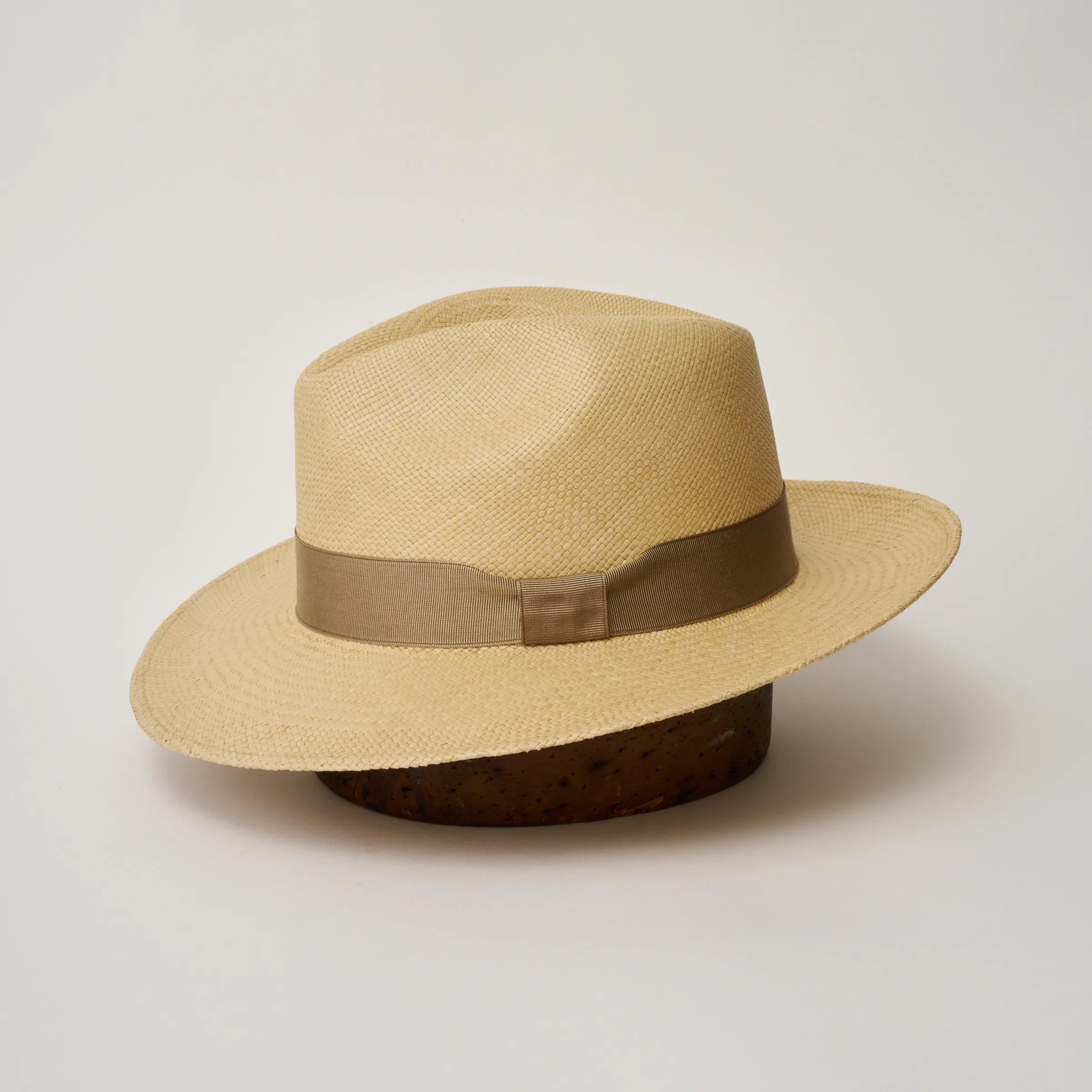 Studio image of the Camilo Classic Sand coloured Panama Hat with Taupe trim shown from the side, showing brim and ribbon finish.