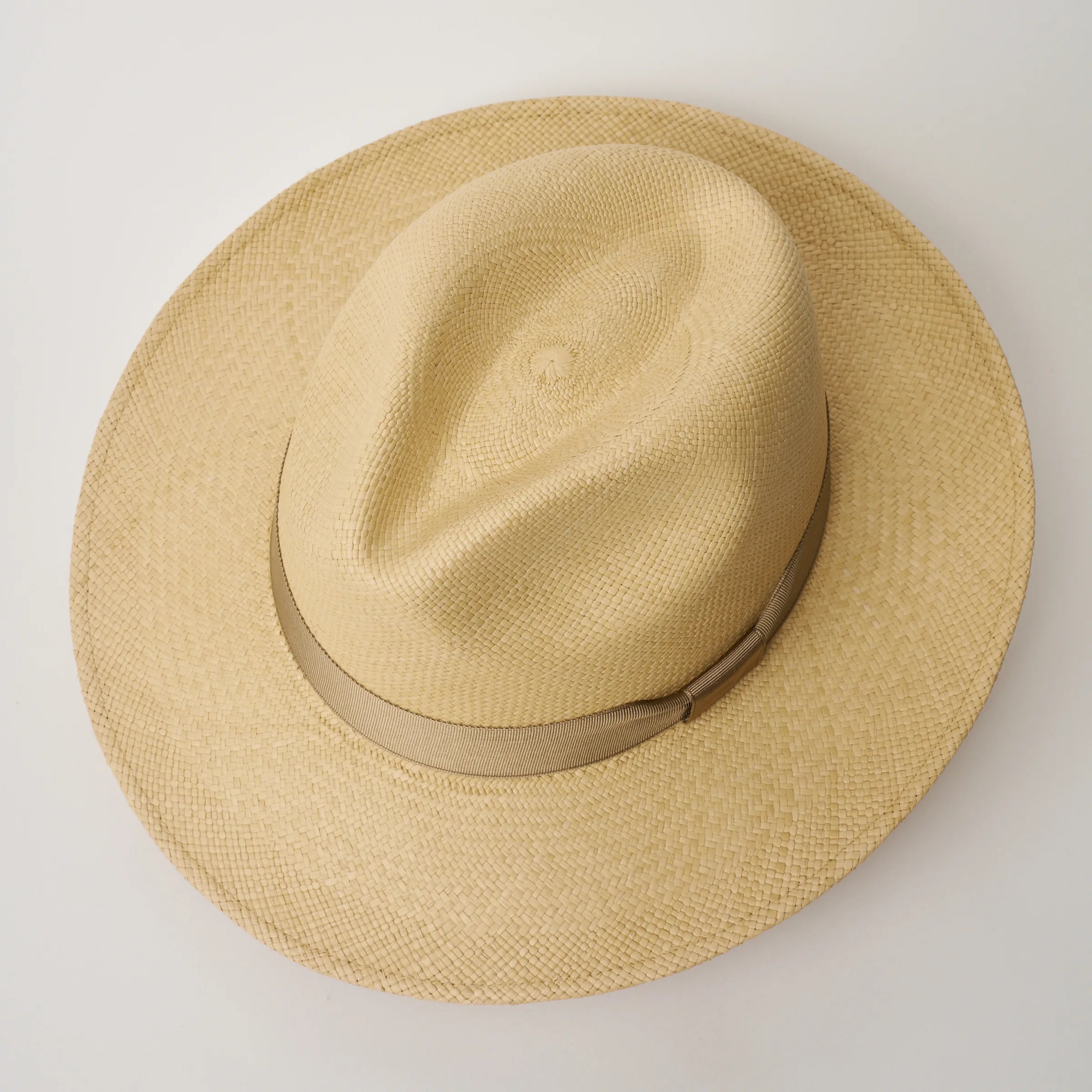 Studio image, taken looking down at the Camilo Classic Sand coloured Panama Hat with Taupe trim, showing the crown shape and pinch.