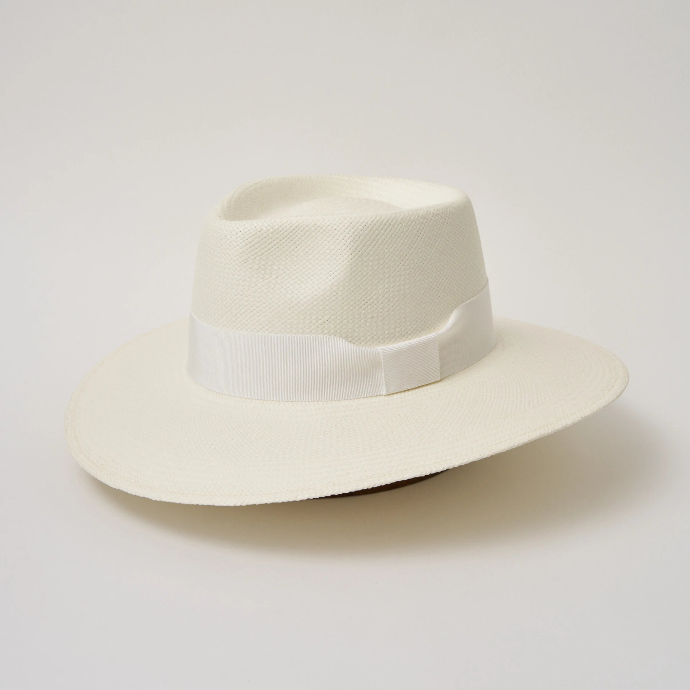 Studio image, angled view of the Camilo Country Cream coloured Panama Hat with White trim, showing the overall hat shape.