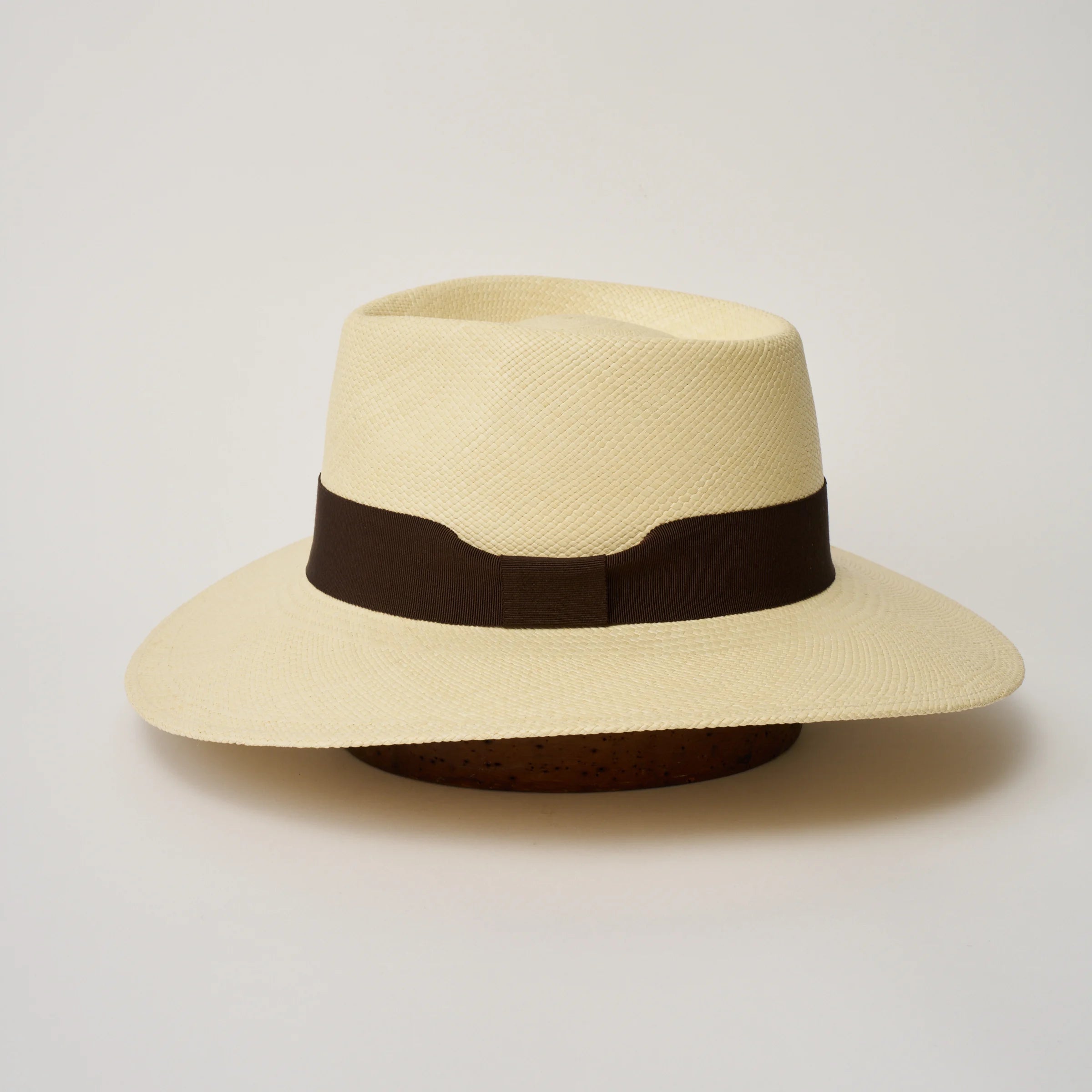 Studio image of the Camilo Country Natural coloured Panama Hat with Chocolate trim shown from the side, showing the brim shape and ribbon finish.