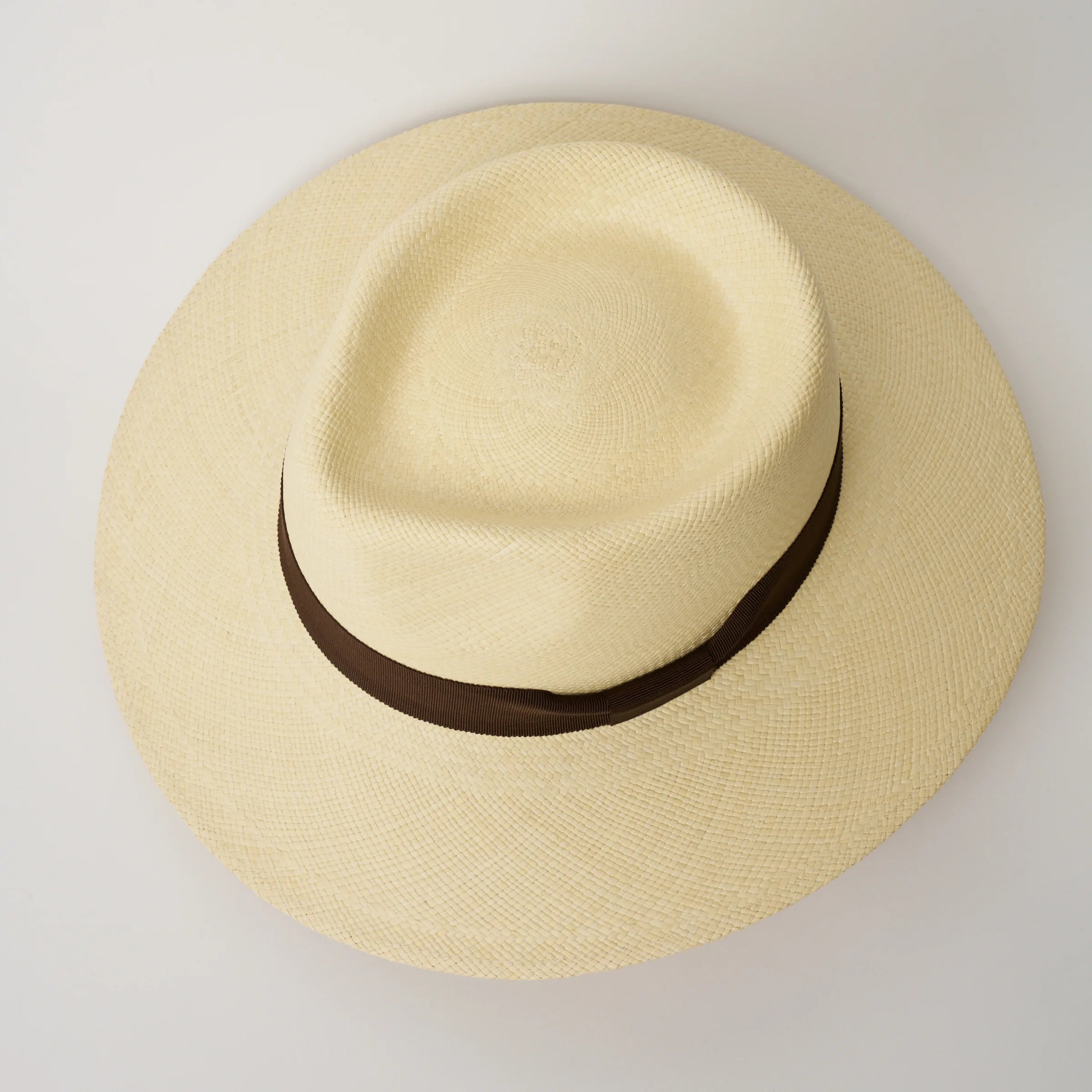 Studio image, looking top-down on the Camilo Country Natural coloured Panama Hat with Chocolate trim, showing the crown shape.