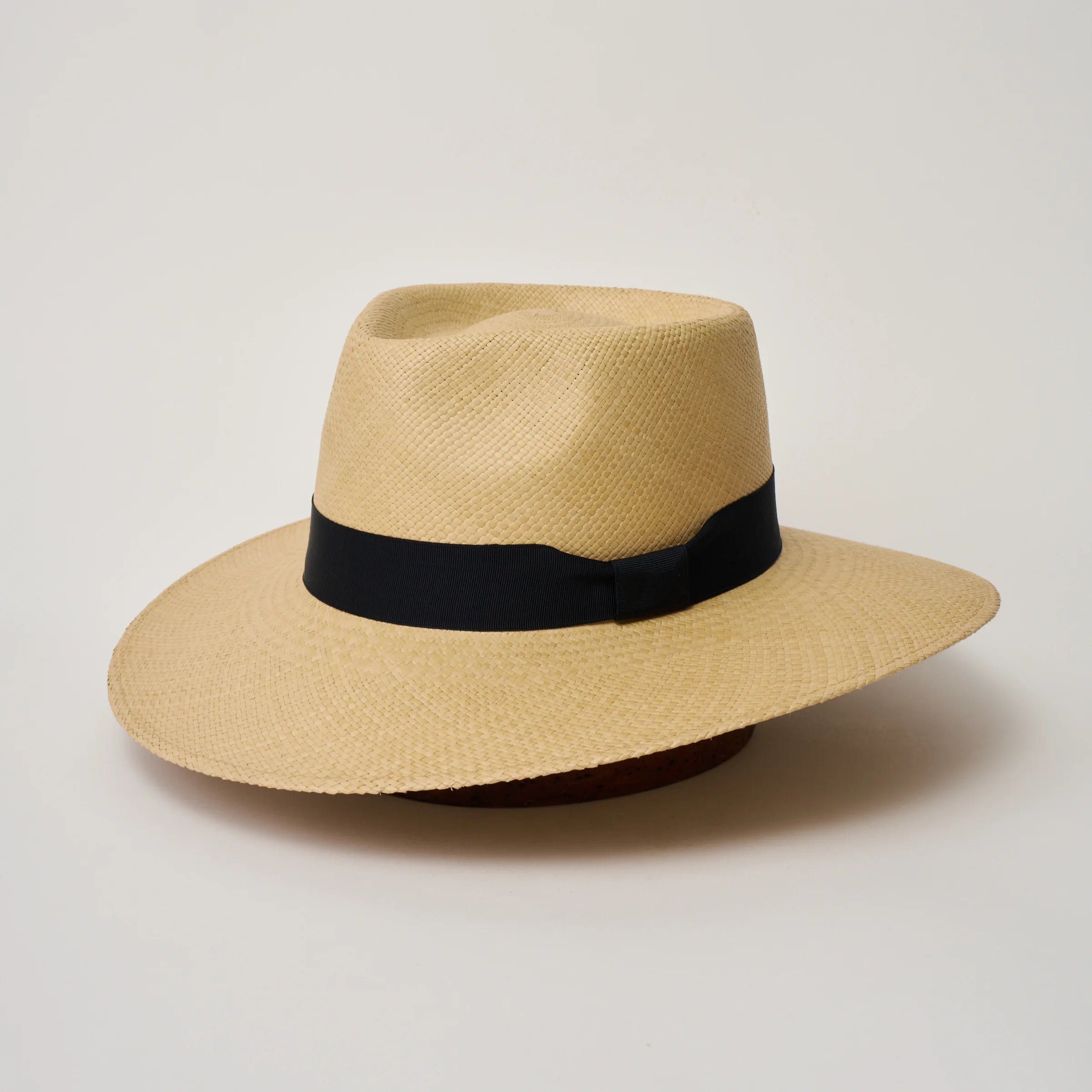Studio image of the Camilo Country Sand coloured Panama Hat with Marine trim, angled showing the crown shape, front crease and ribbon details.