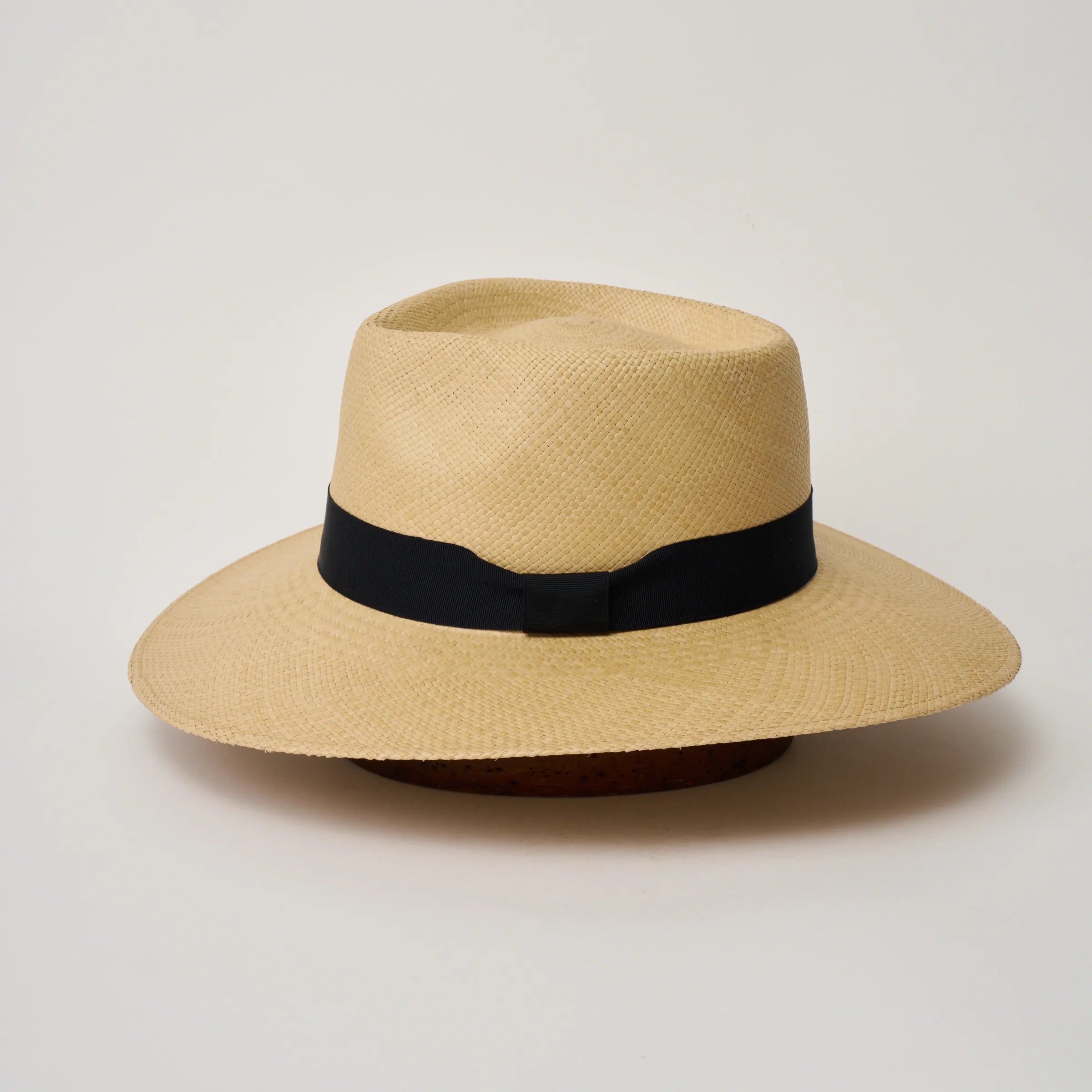 Studio image of the Camilo Country 
Sand coloured Panama Hat with Marine trim shown from the side, showing the brim shape and ribbon finish.