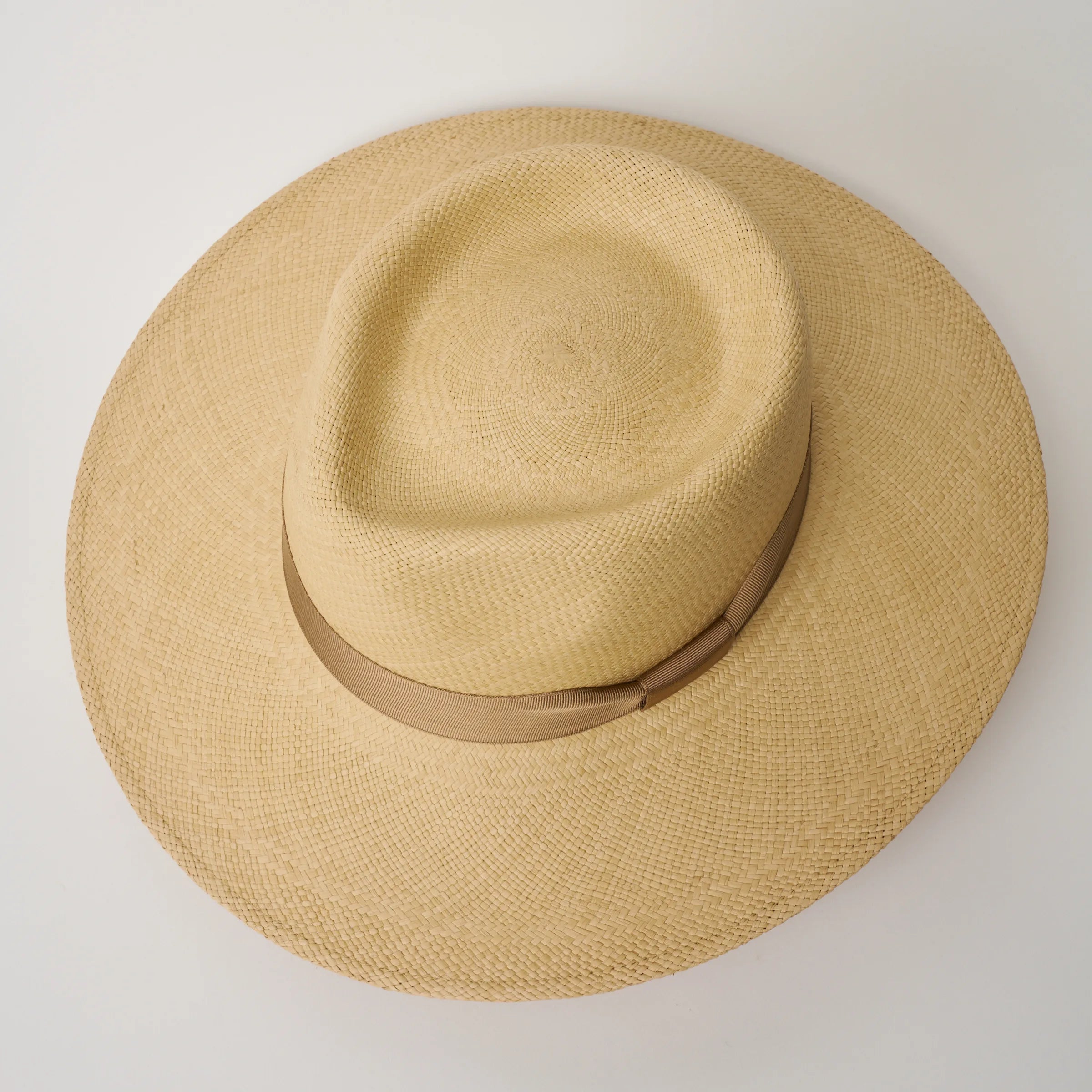 Studio image, looking top-down on the Camilo Country Sand coloured Panama Hat with Tan trim, showing the crown shape.