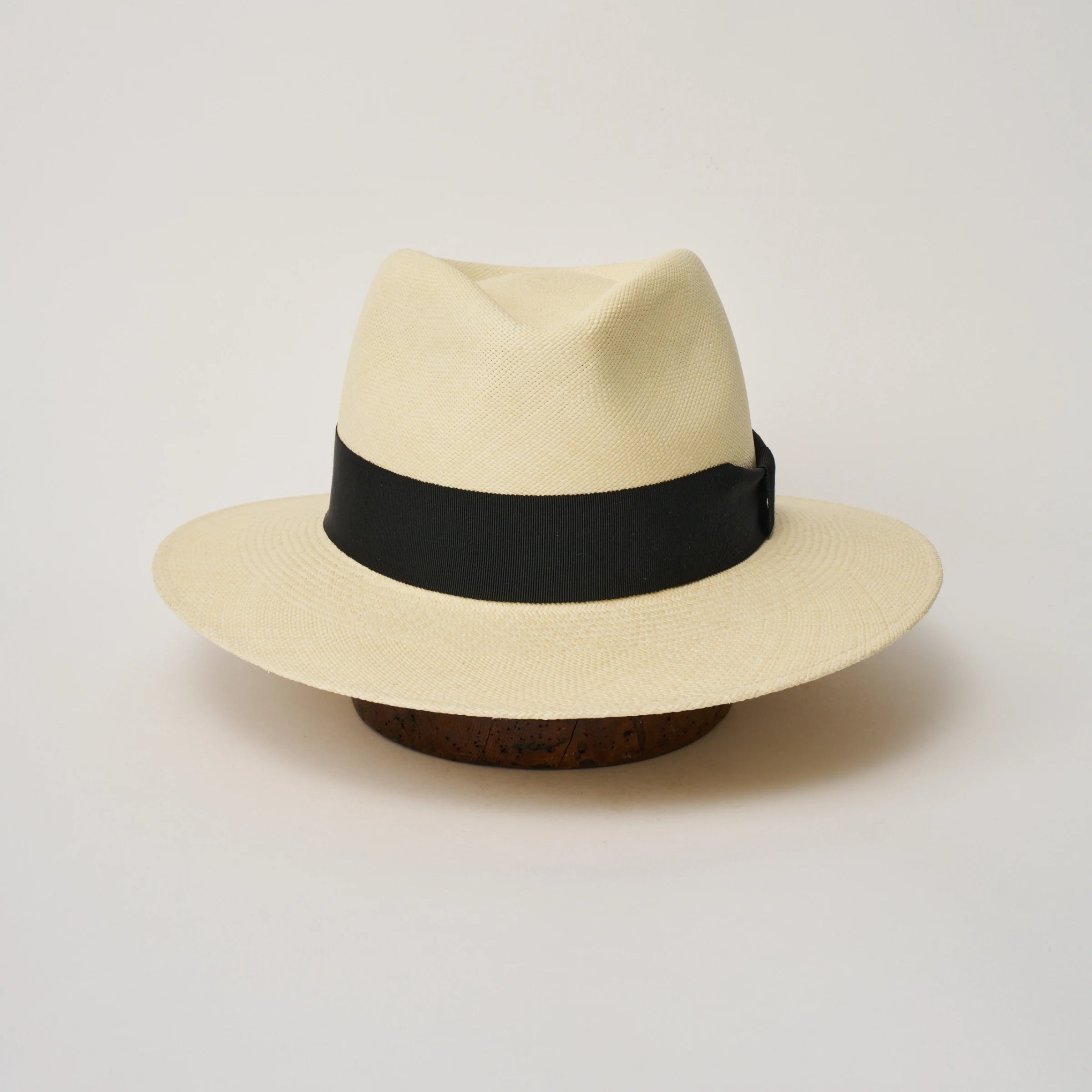 Studio image of the Camilo Executive Fino Natural coloured Panama Hat with Black trim taken from the front, showing pinch.