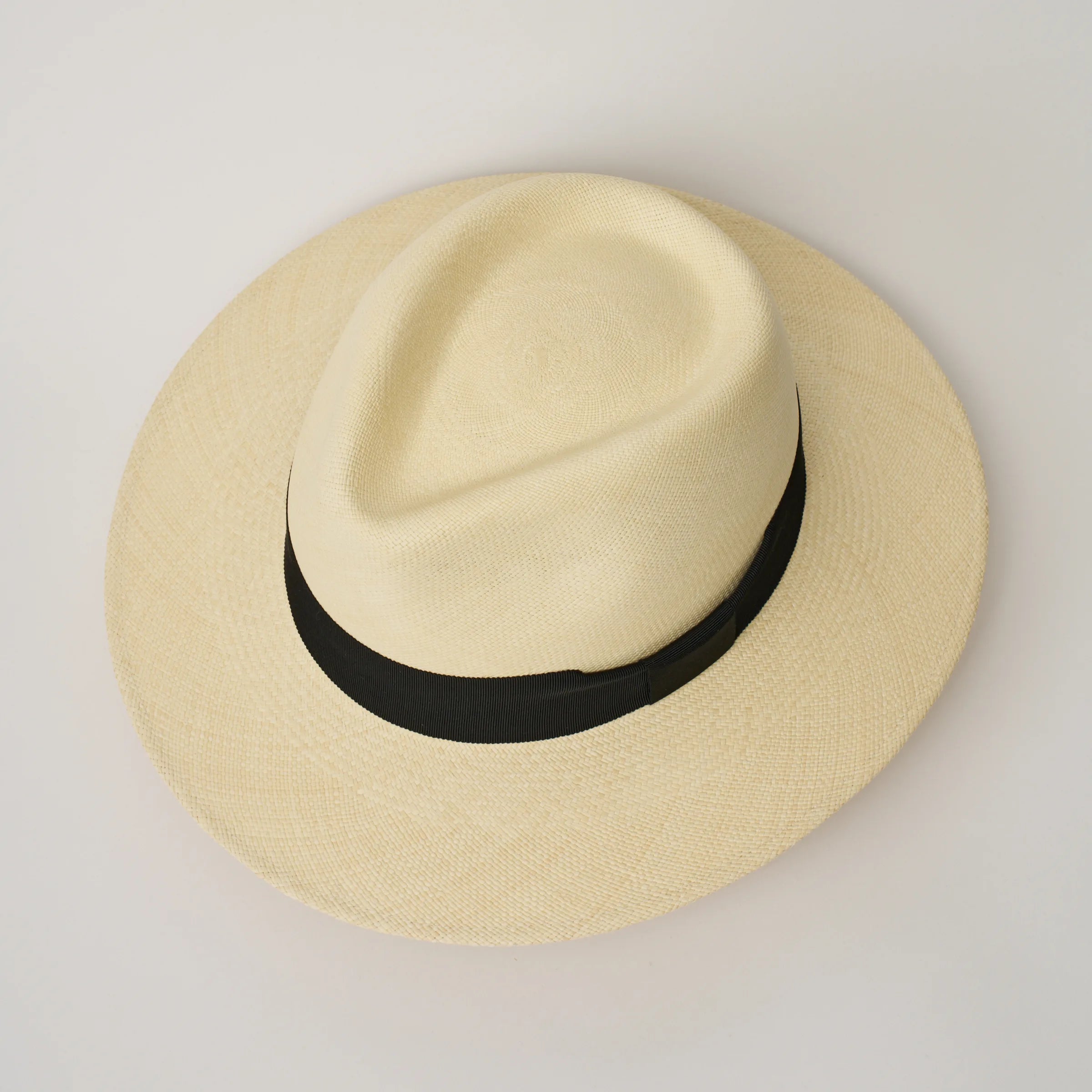 Studio image, looking top-down on the Camilo Executive Fino Natural coloured Panama Hat with Black trim, showing the crown shape.