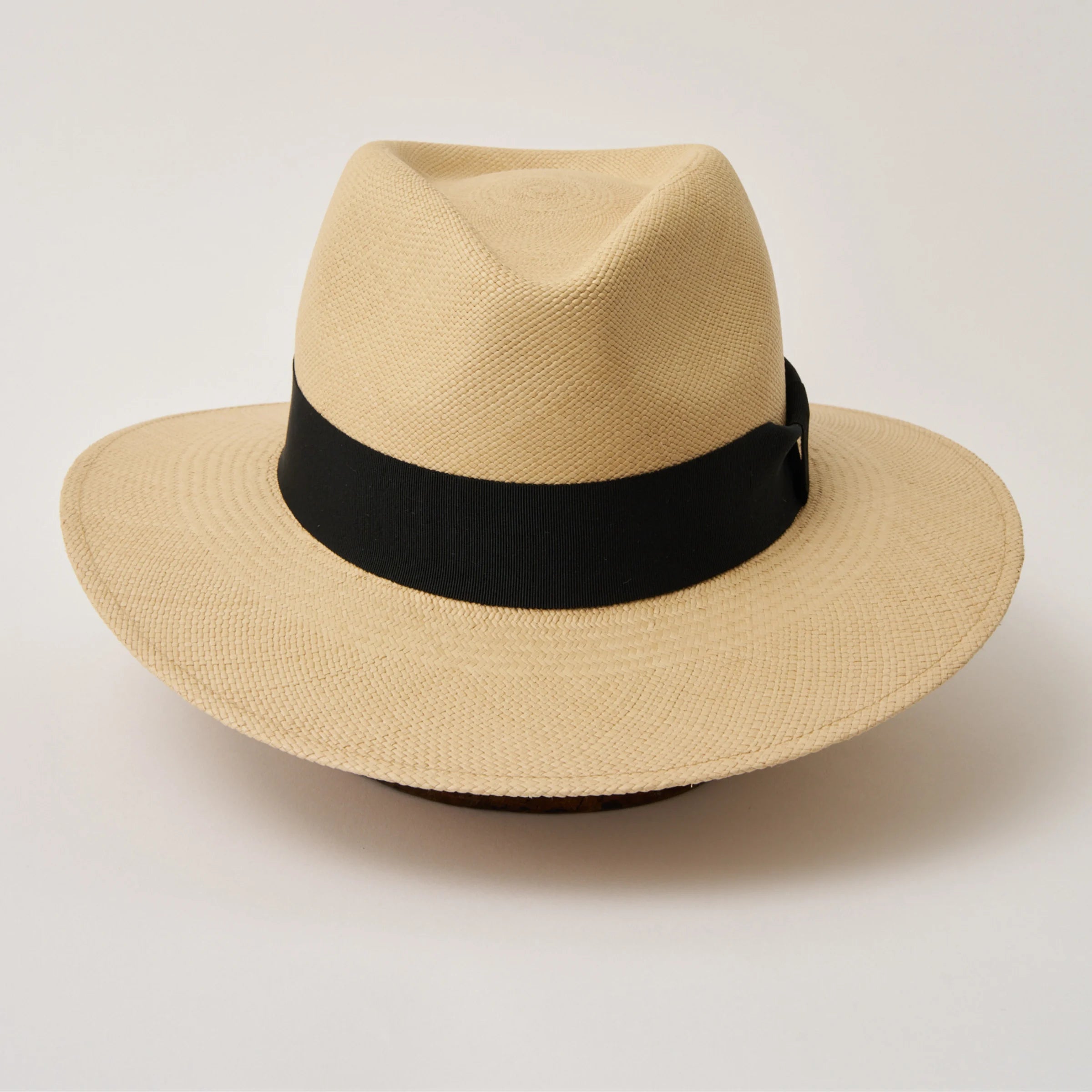 Studio image of the Camilo Executive Fino Sand coloured Panama Hat with Black trim taken from the front, showing pinch.