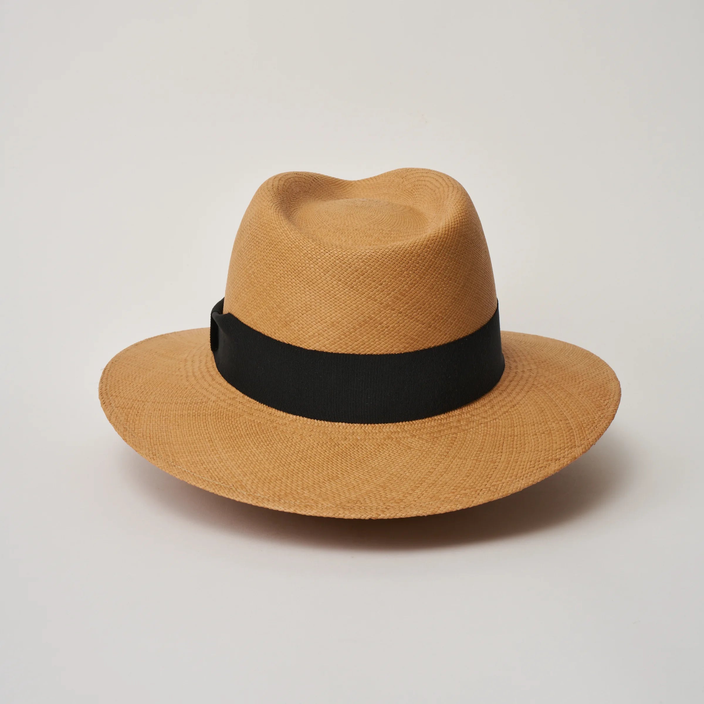 Studio image of the Camilo Executive Fino Toffee coloured Panama Hat with Black trim taken from the back.