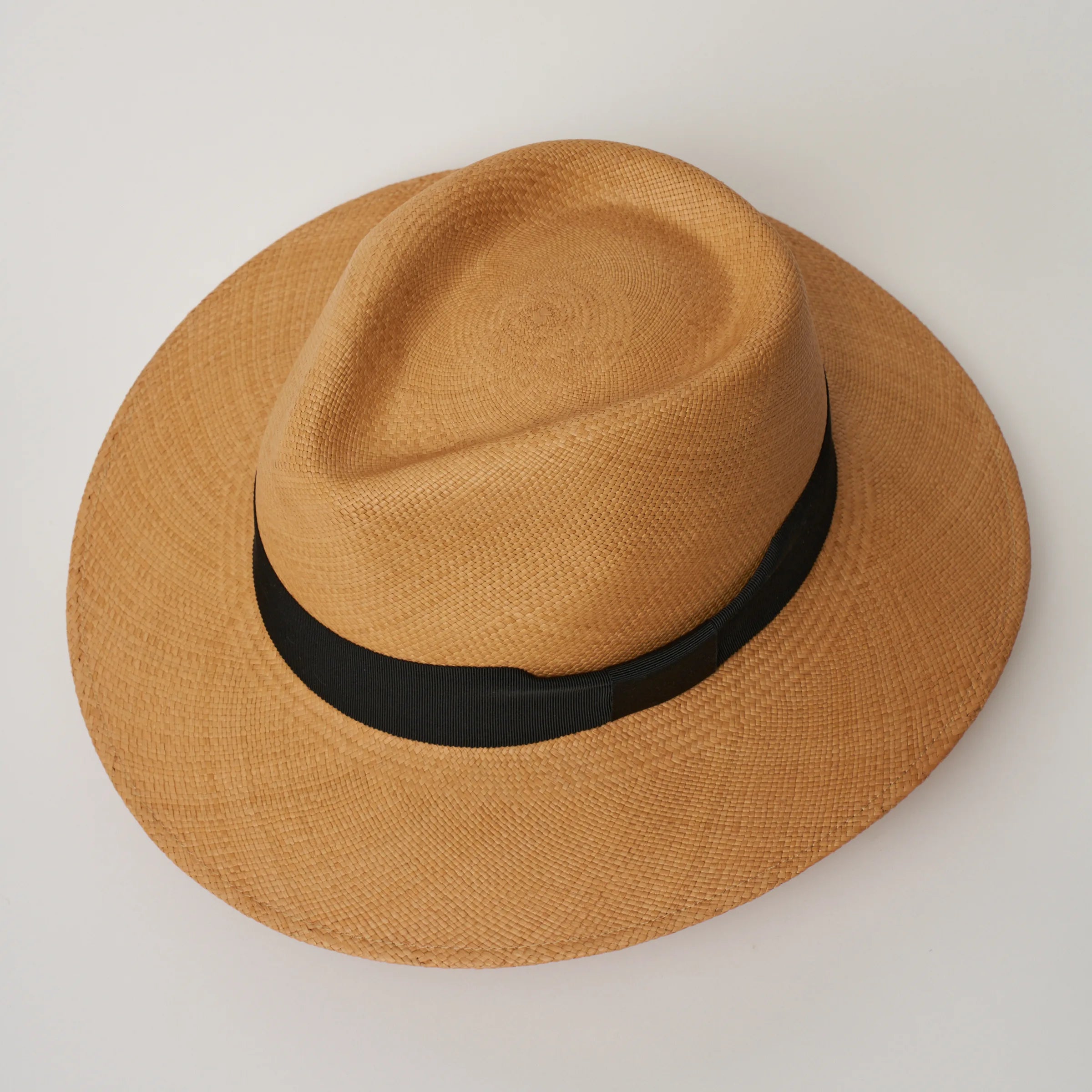 Studio image, looking top-down on the Camilo Executive Fino Toffee coloured Panama Hat with Black trim, showing the crown shape.