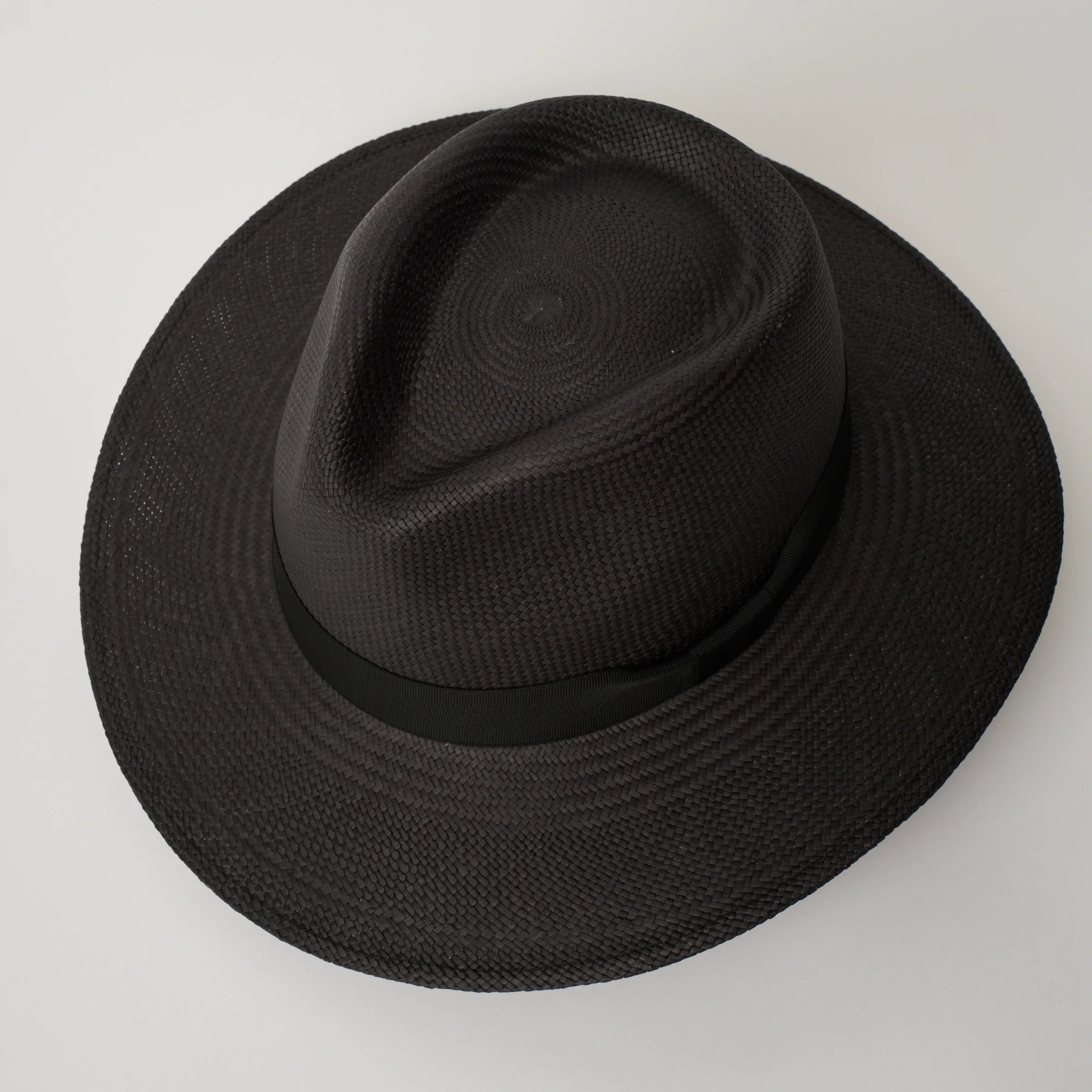 Studio image, looking top-down on the Camilo Executive Black coloured Panama Hat with Black trim, showing the crown shape.