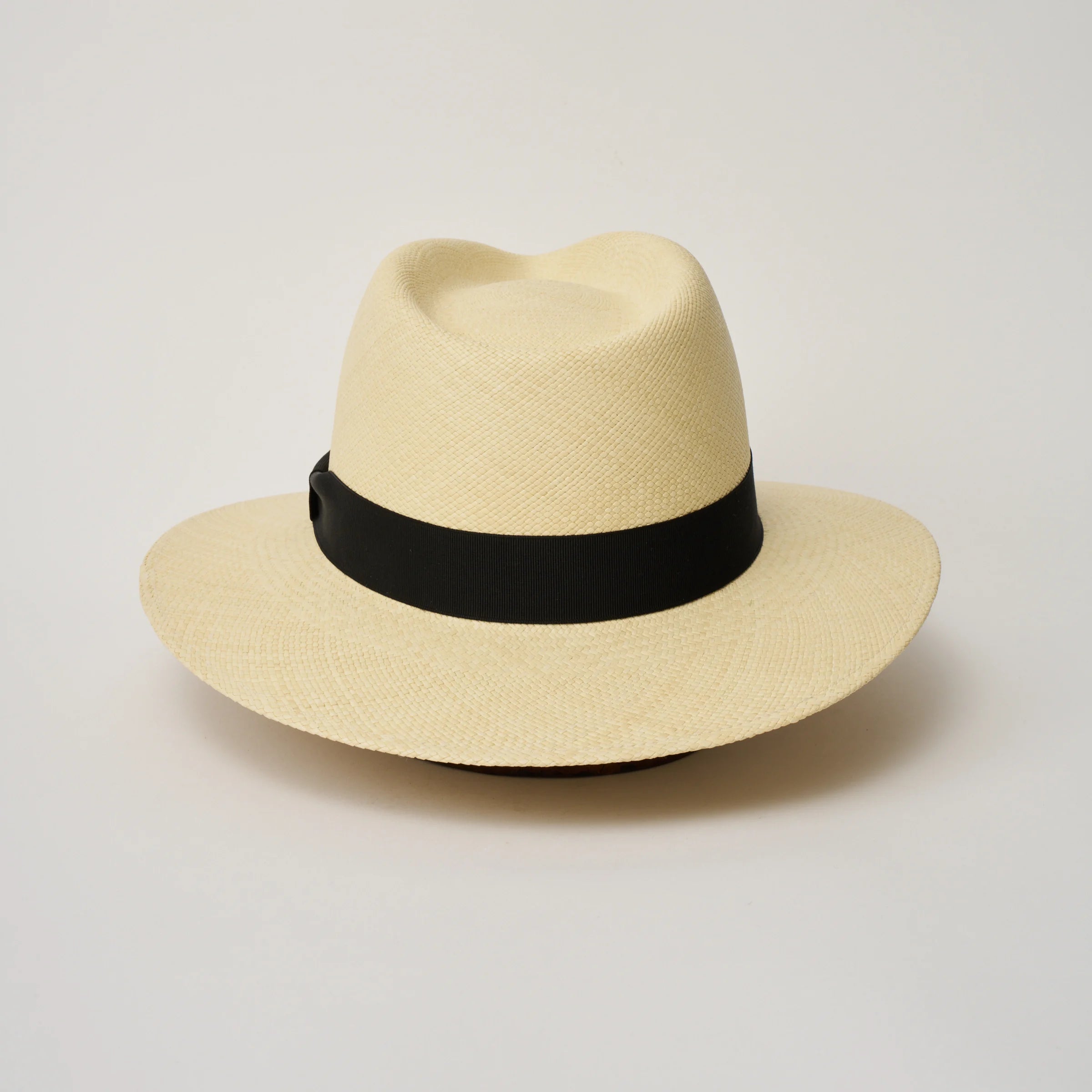 Studio image of the Camilo Executive Natural coloured Panama Hat with Black trim taken from the back.