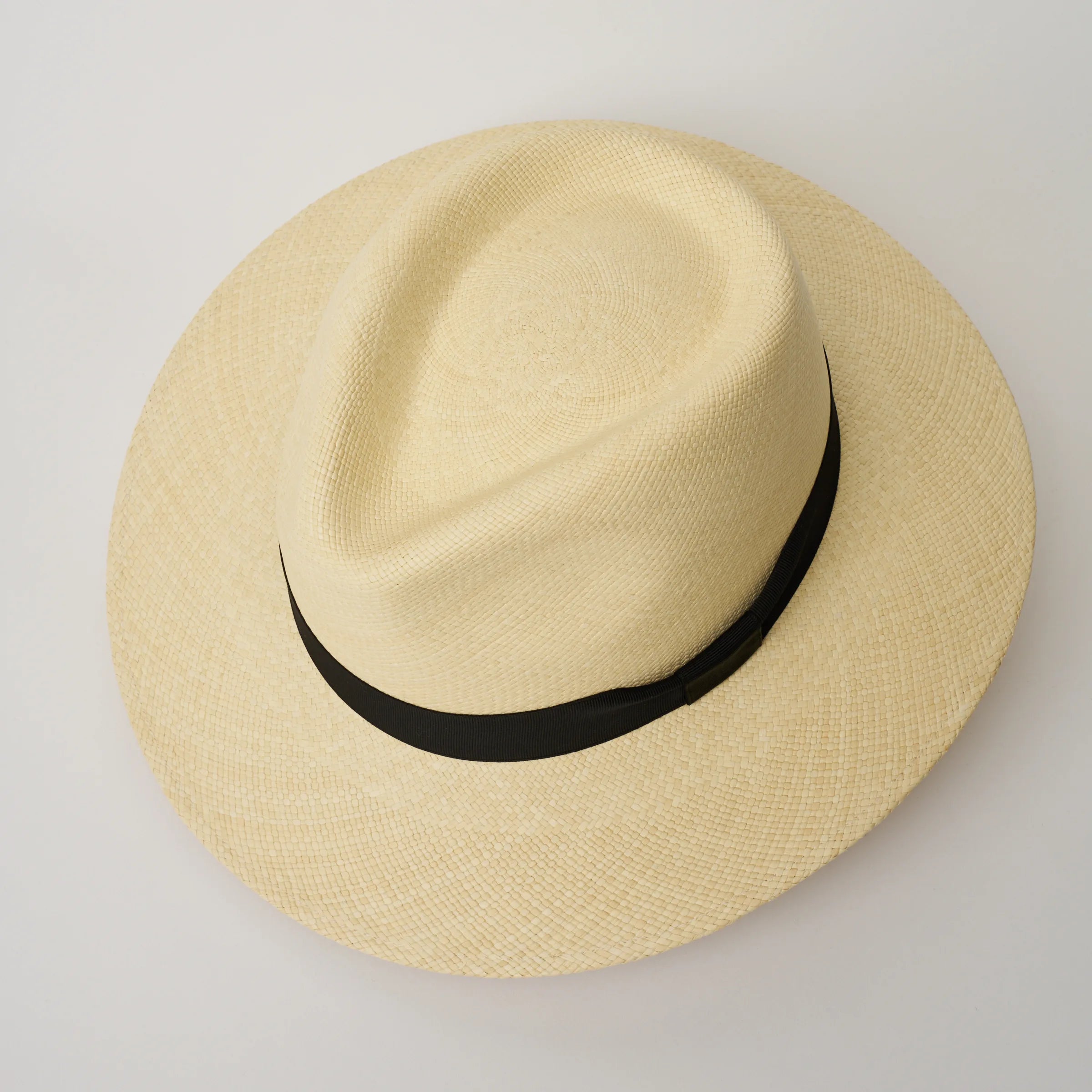 Studio image, looking top-down on the Camilo Executive Natural coloured Panama Hat with Black trim, showing the crown shape.