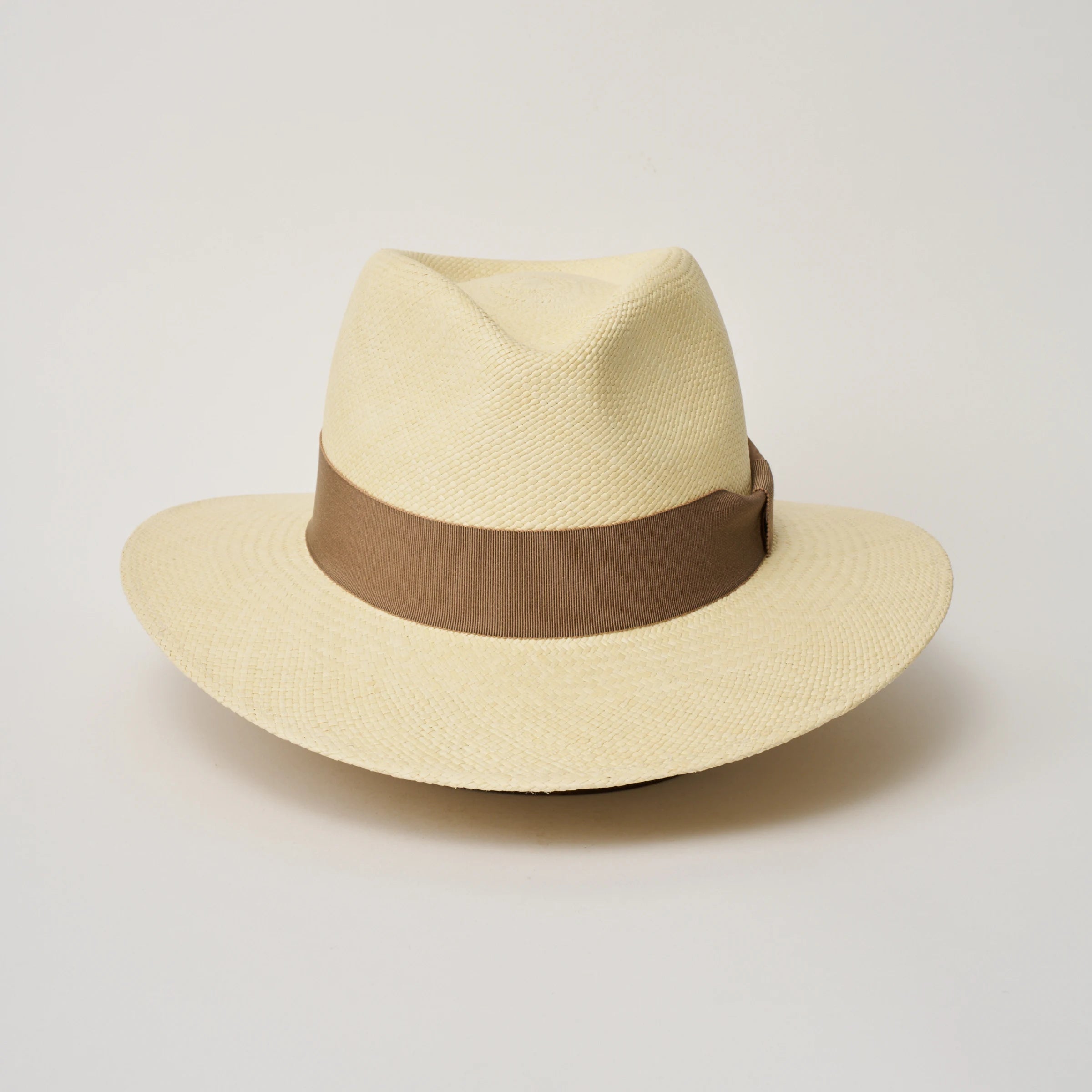 Studio image of the Camilo Executive Natural coloured Panama Hat with Oat trim taken from the front, showing pinch.