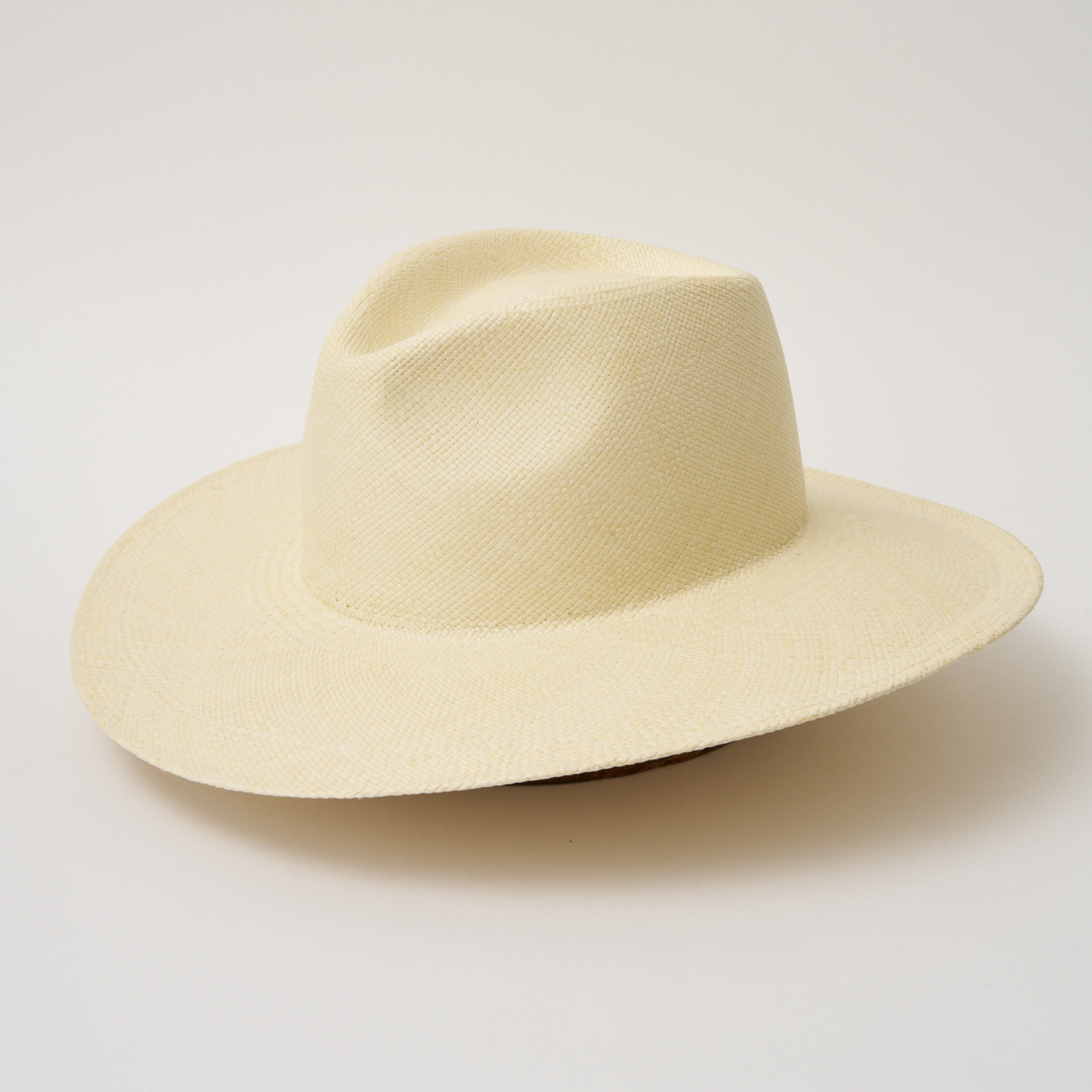 Studio image, angled view of the Camilo Oro Natural coloured Panama Hat, showing the overall hat shape.