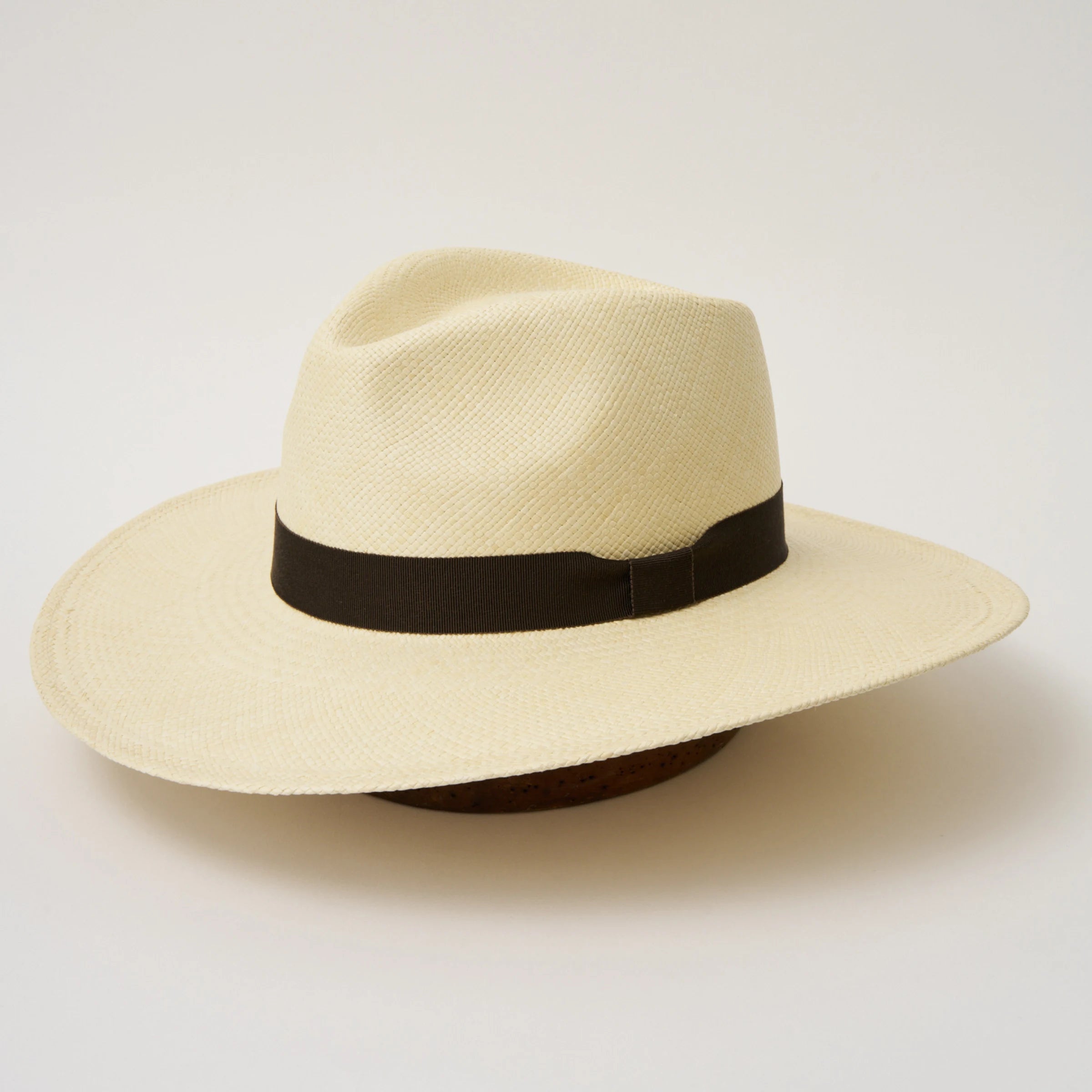 Studio image, angled view of the Camilo Oro Natural coloured Panama Hat with Espresso trim, showing the overall hat shape.