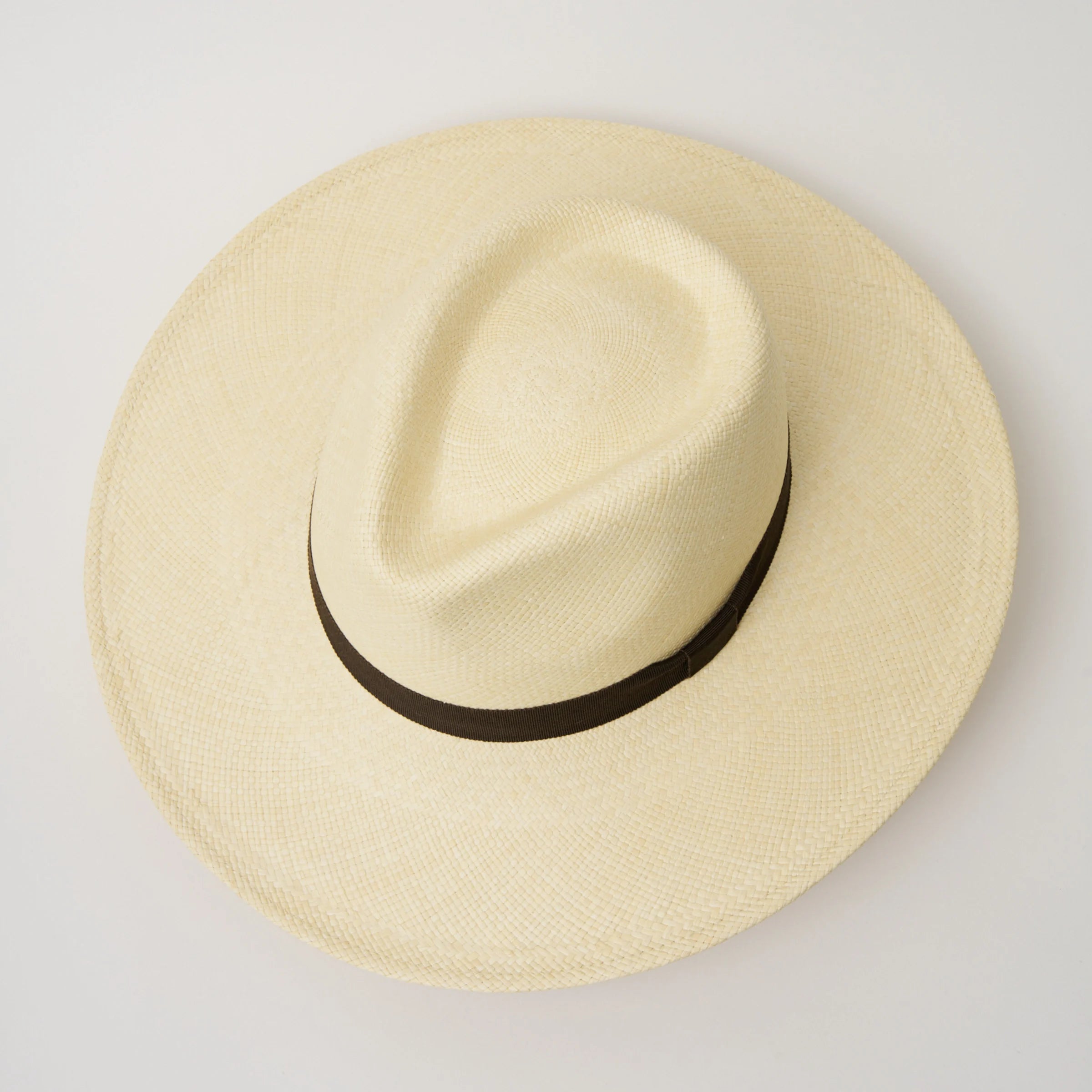 Studio image, taken looking down at the Camilo Oro Natural coloured Panama Hat with Espresso trim, showing the crown shape and pinch.