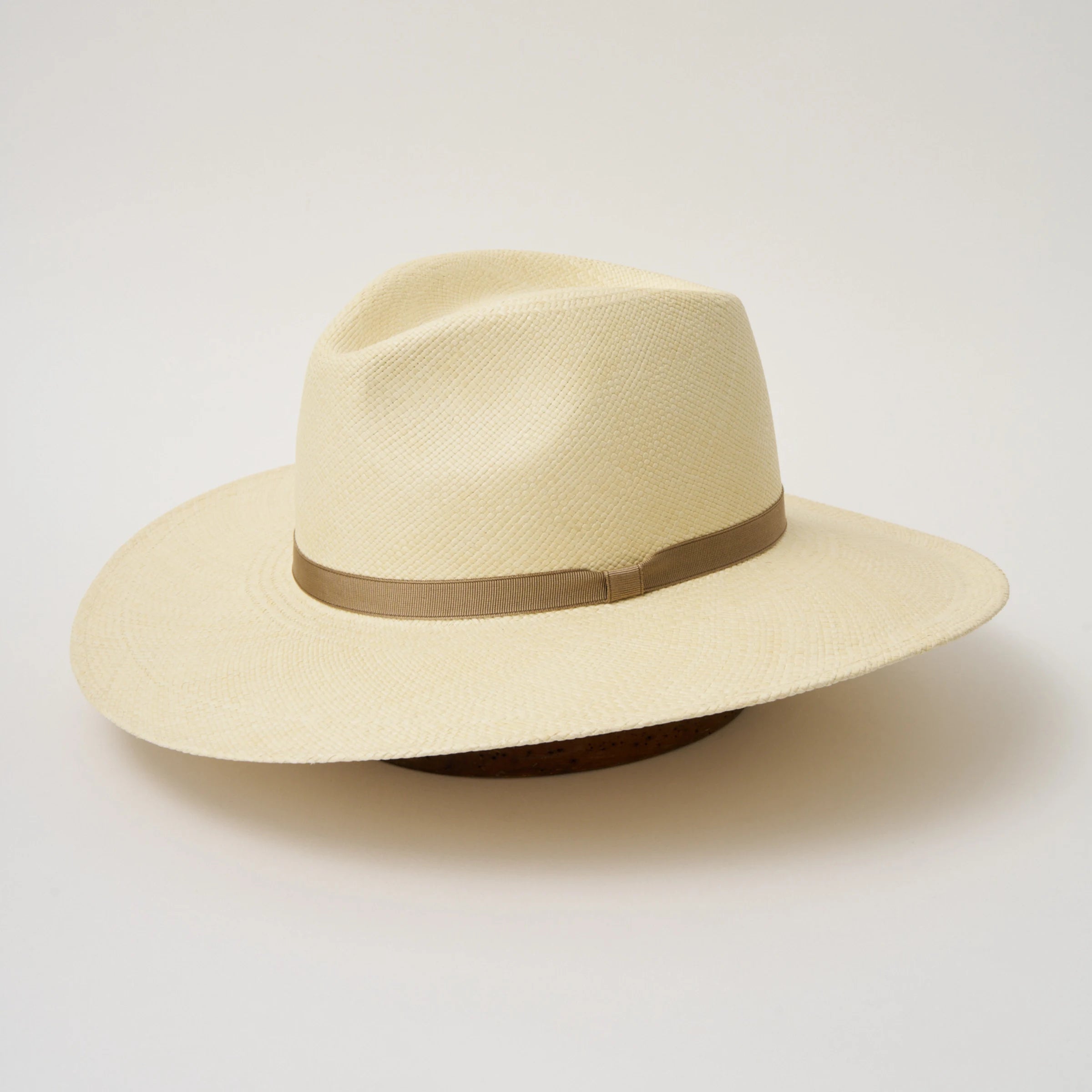 Studio image, angled view of the Camilo Oro Natural coloured Panama Hat with Taupe trim, showing the overall hat shape.
