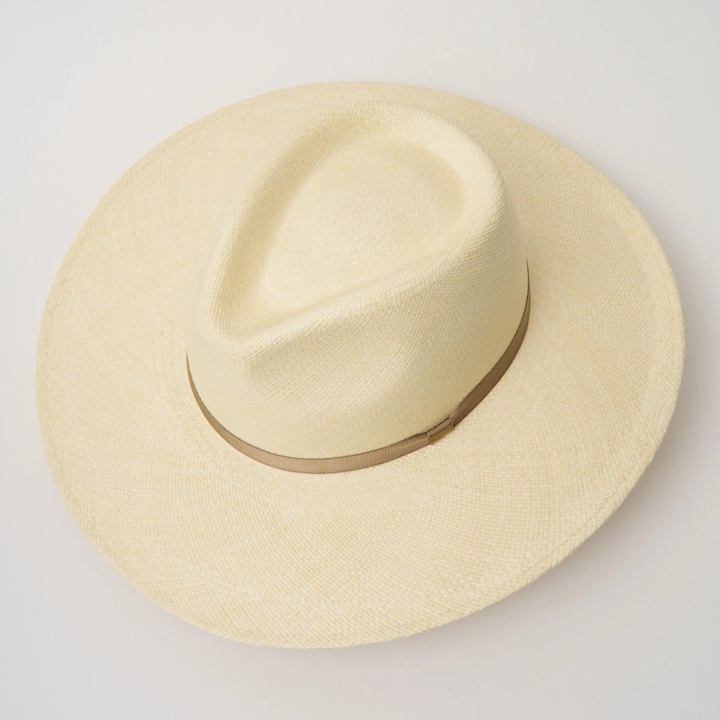 Studio image, taken looking down at the Camilo Oro Natural coloured Panama Hat with Taupe trim, showing the crown shape and pinch.