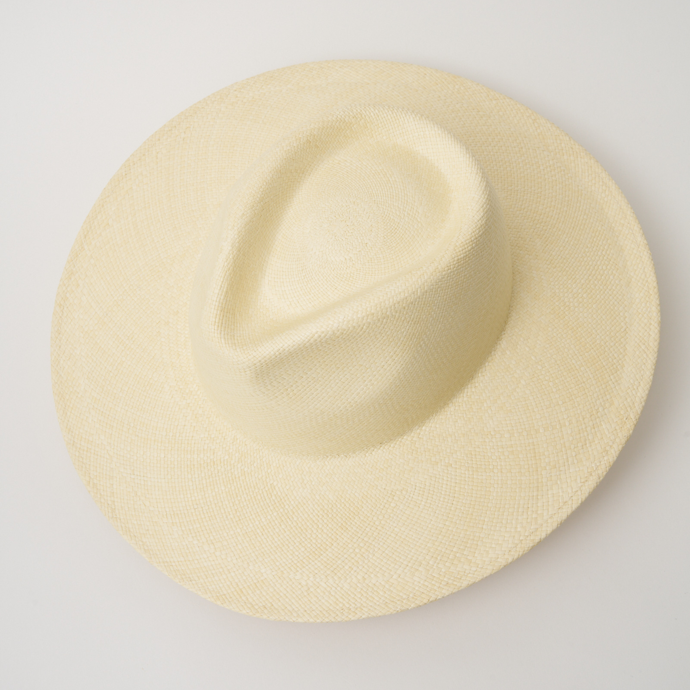 Studio image, taken looking down at the Camilo Oro Natural coloured Panama Hat, showing the crown shape and pinch.