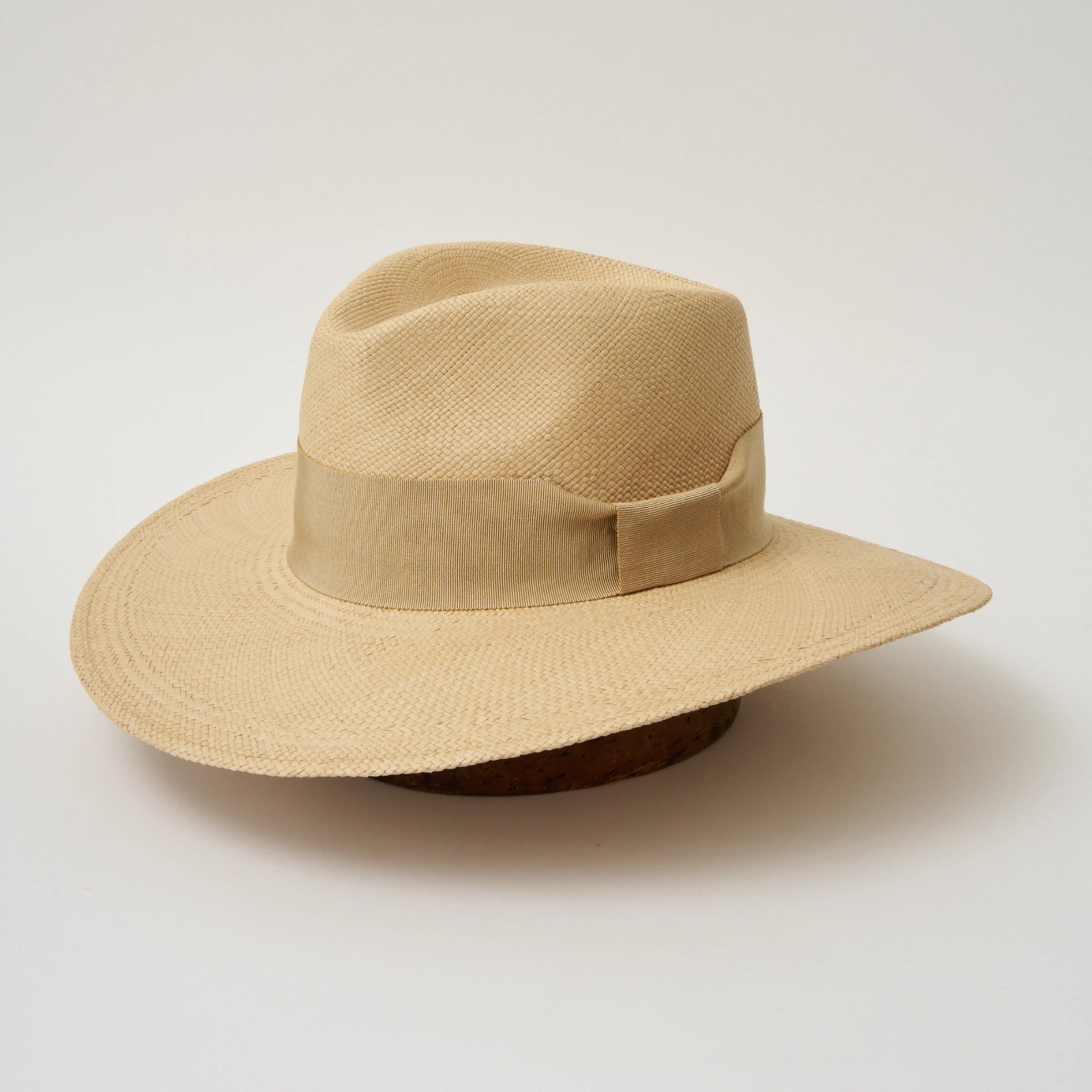 Studio image, angled view of the Camilo Oro Sand coloured Panama Hat with Camel trim, showing the overall hat shape.