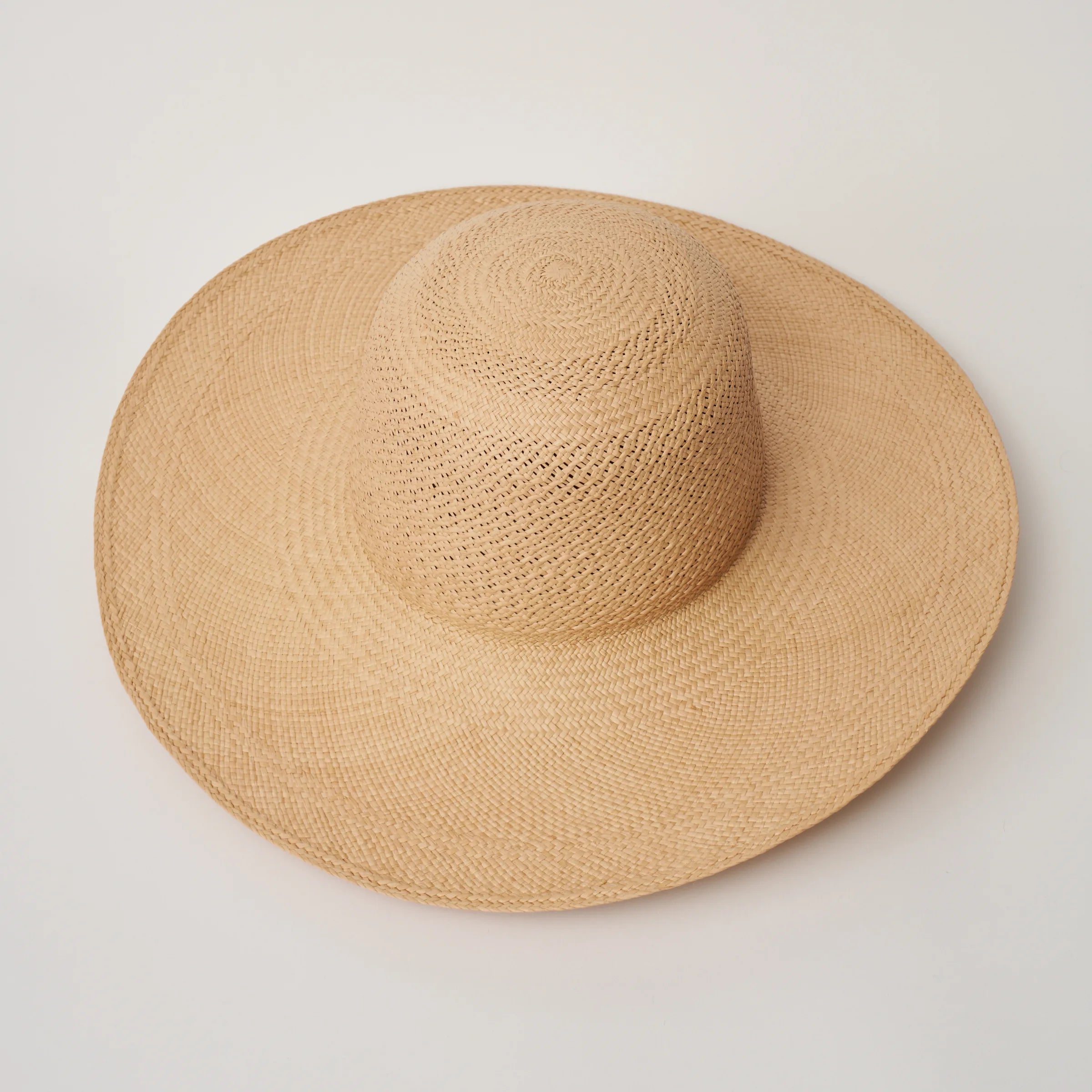 Studio image, angle view of the Rio Sand coloured Panama Hat, showing the open crown shape, crochet detail and brim width.