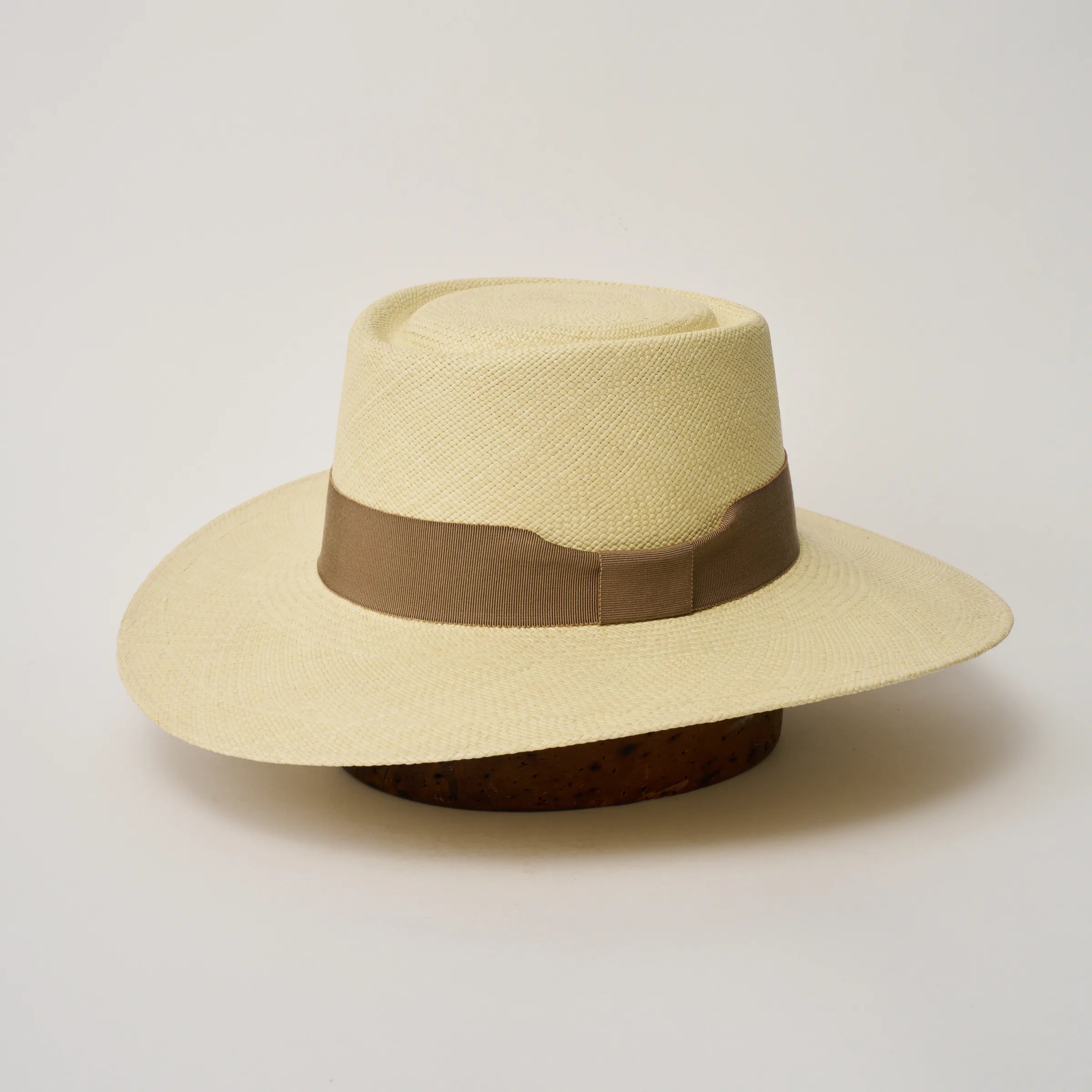 Studio image of the Camilo Sol Natural coloured Panama Hat with Oat trim, angled showing the crown shape and ribbon details.