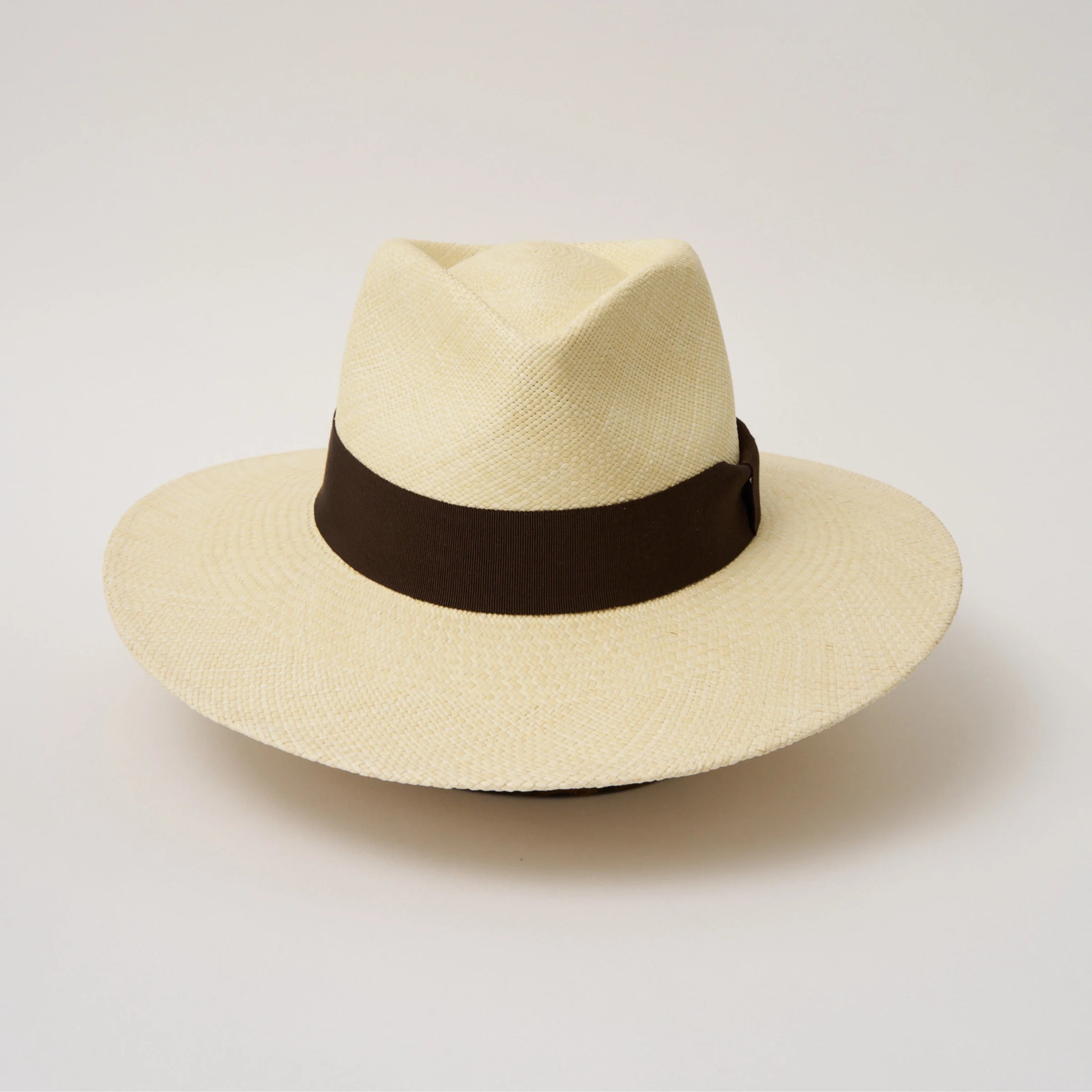 Studio image of the Camilo Vita Natural coloured Panama Hat with Chocolate trim taken from the front showing pinch and brim.