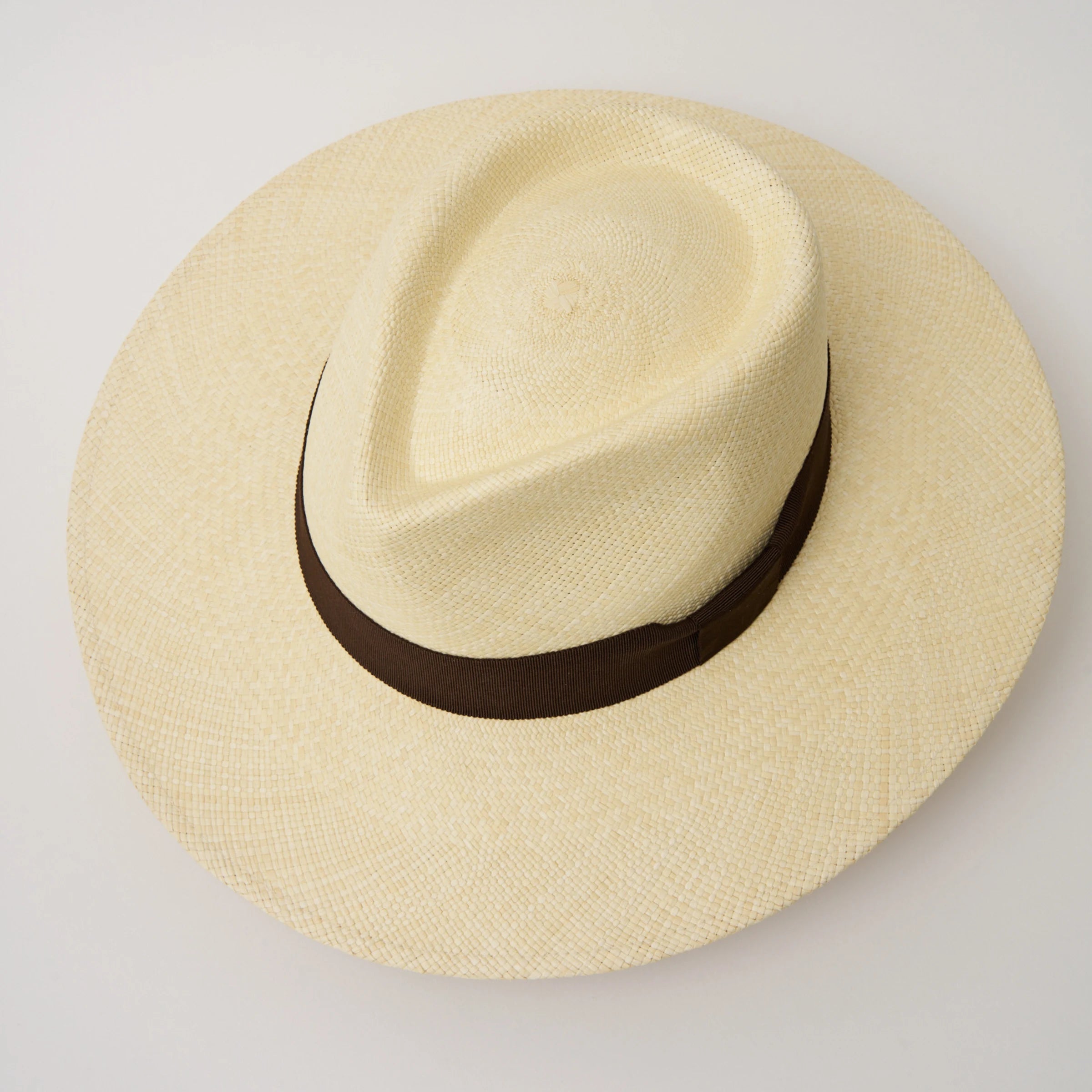 Studio image, taken looking down at the Camilo Vita Natural coloured Panama Hat with Chocolate trim, showing the crown shape and pinch.