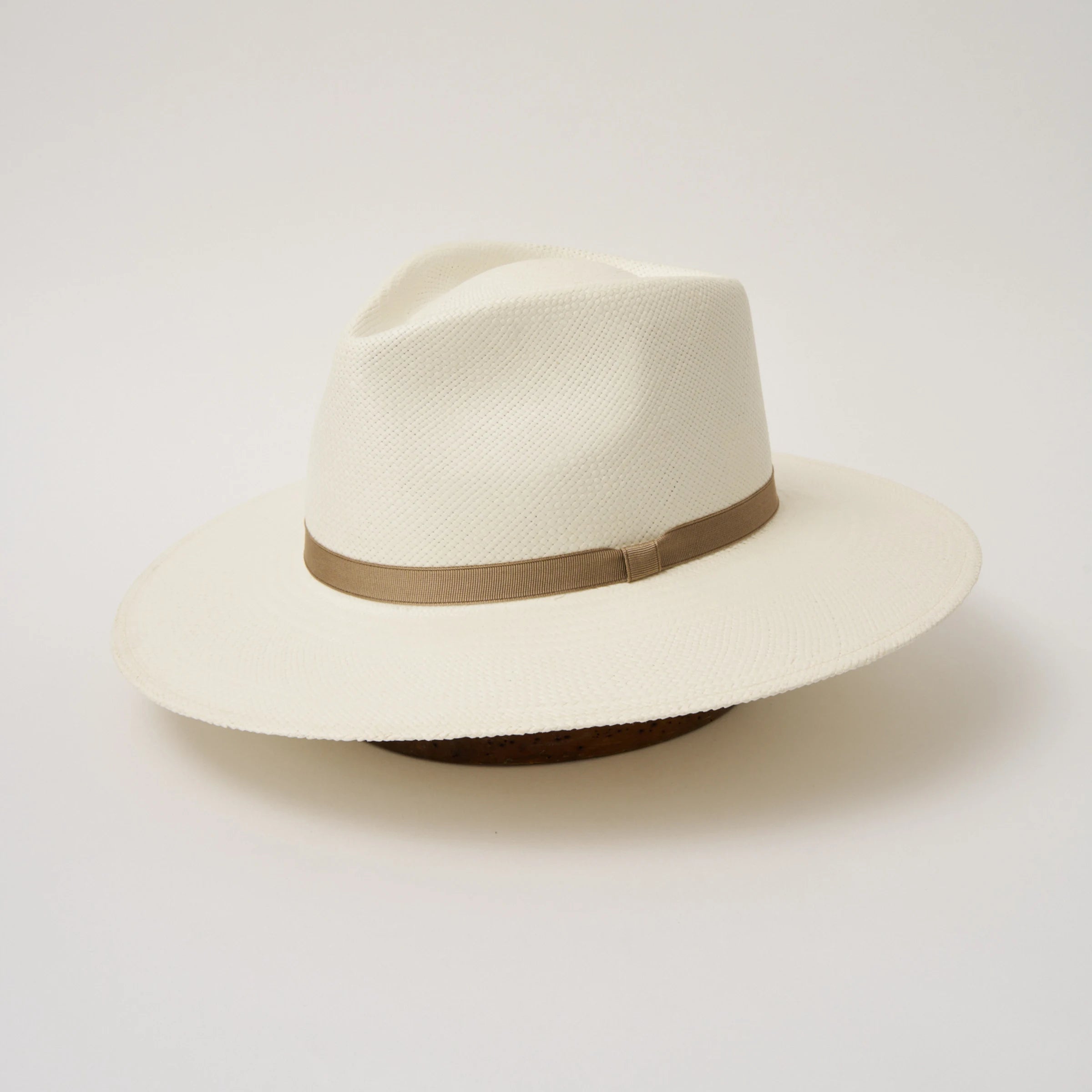 Studio image, angled view of the Camilo Vita Cream coloured Panama Hat with Taupe trim, showing the overall hat shape.