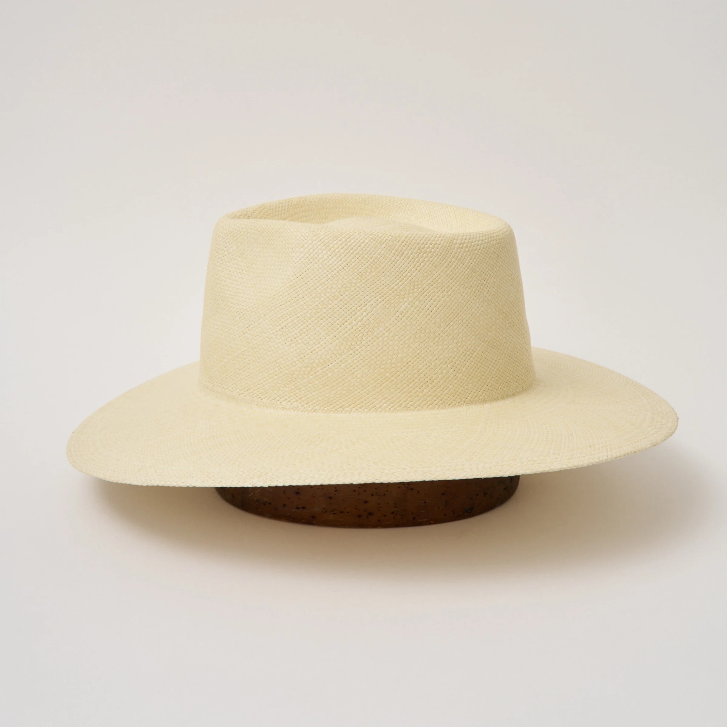Studio image of the Camilo Country Natural coloured Panama Hat taken from the side, showing brim and ribbon finish.
