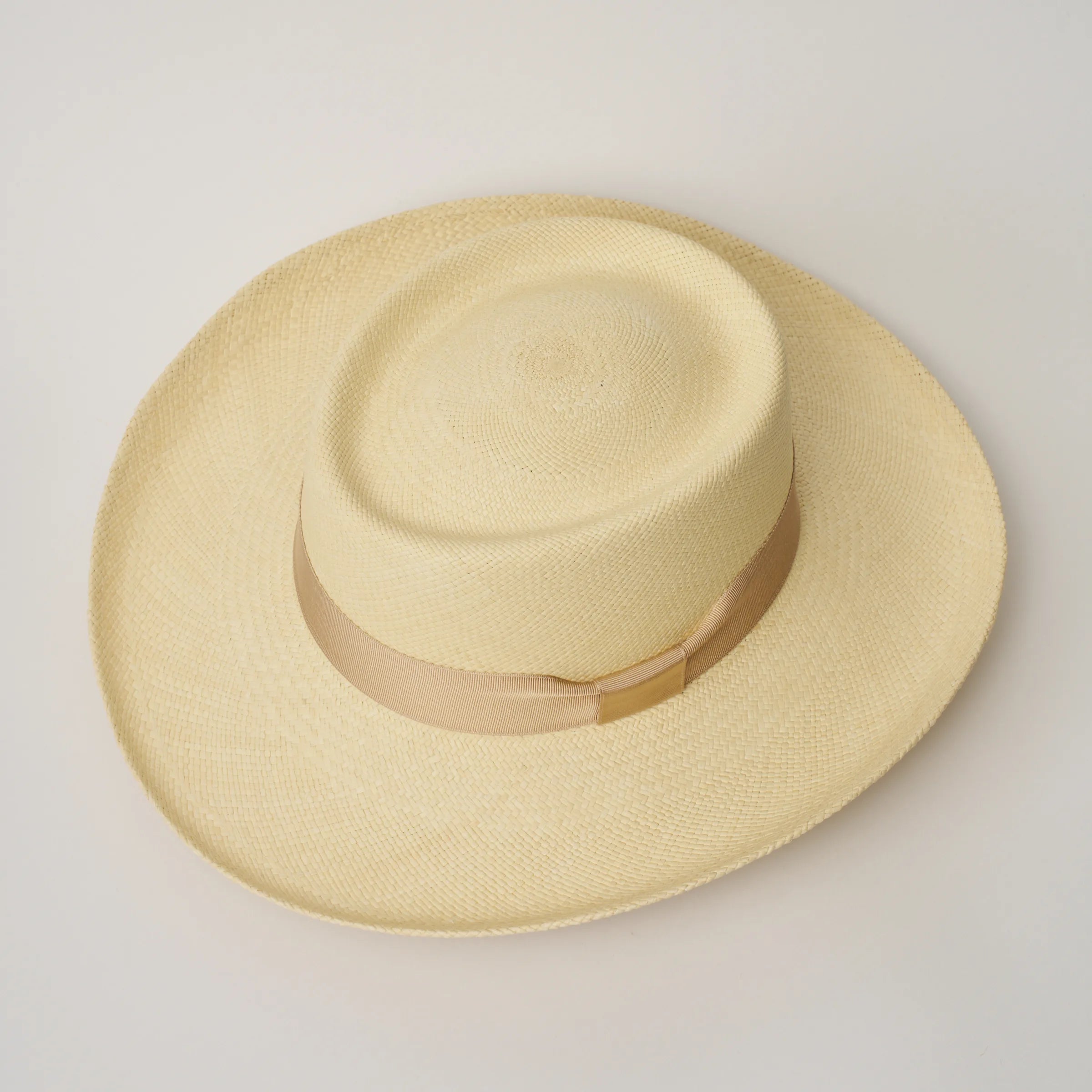 Studio image, looking top-down on the Camilo Gambler Natural coloured Panama Hat with Bone trim, showing the crown shape.