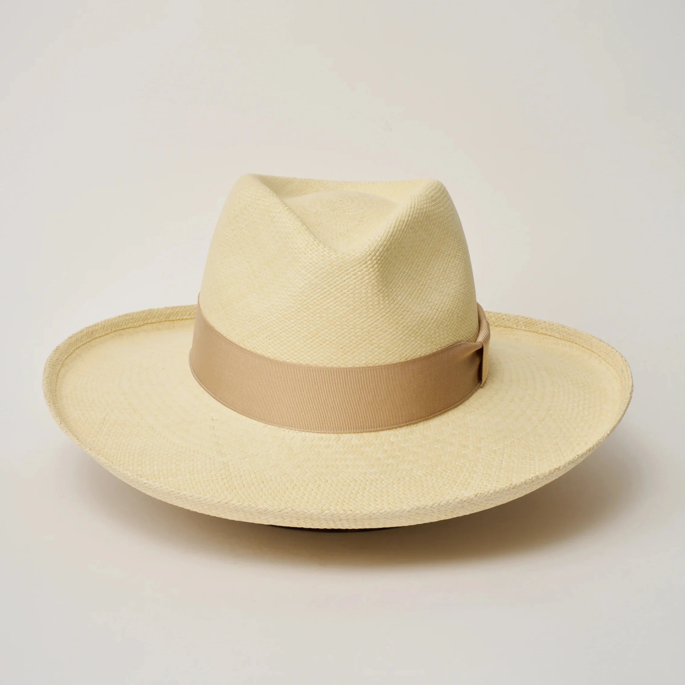 Studio image, looking top-down on the Camilo Grand Planter Natural coloured Panama Hat with Bone trim, showing the crown and brim shape.