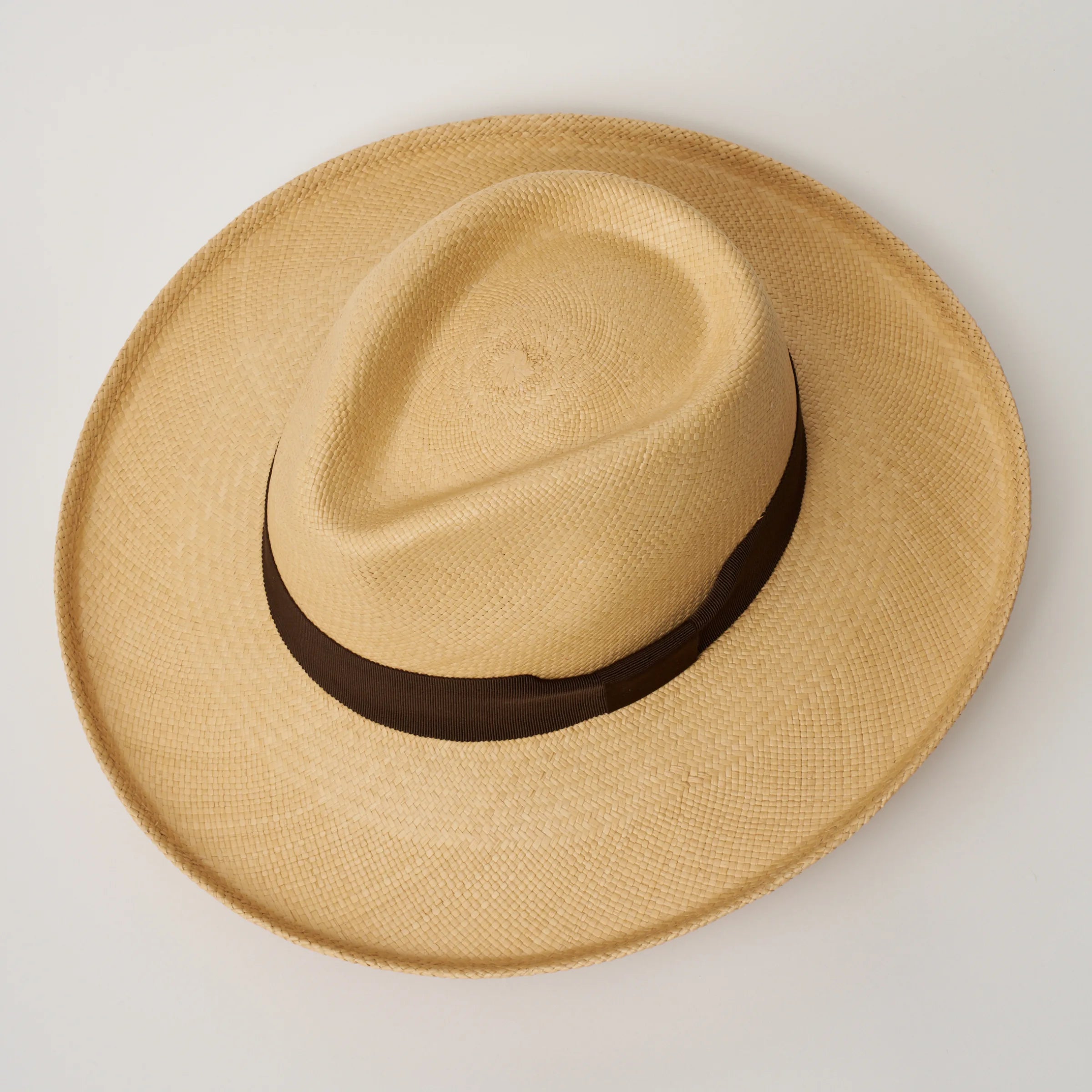 Studio image, looking top-down on the Camilo Grand Planter Sand coloured Panama Hat with Chocolate trim, showing the crown shape.