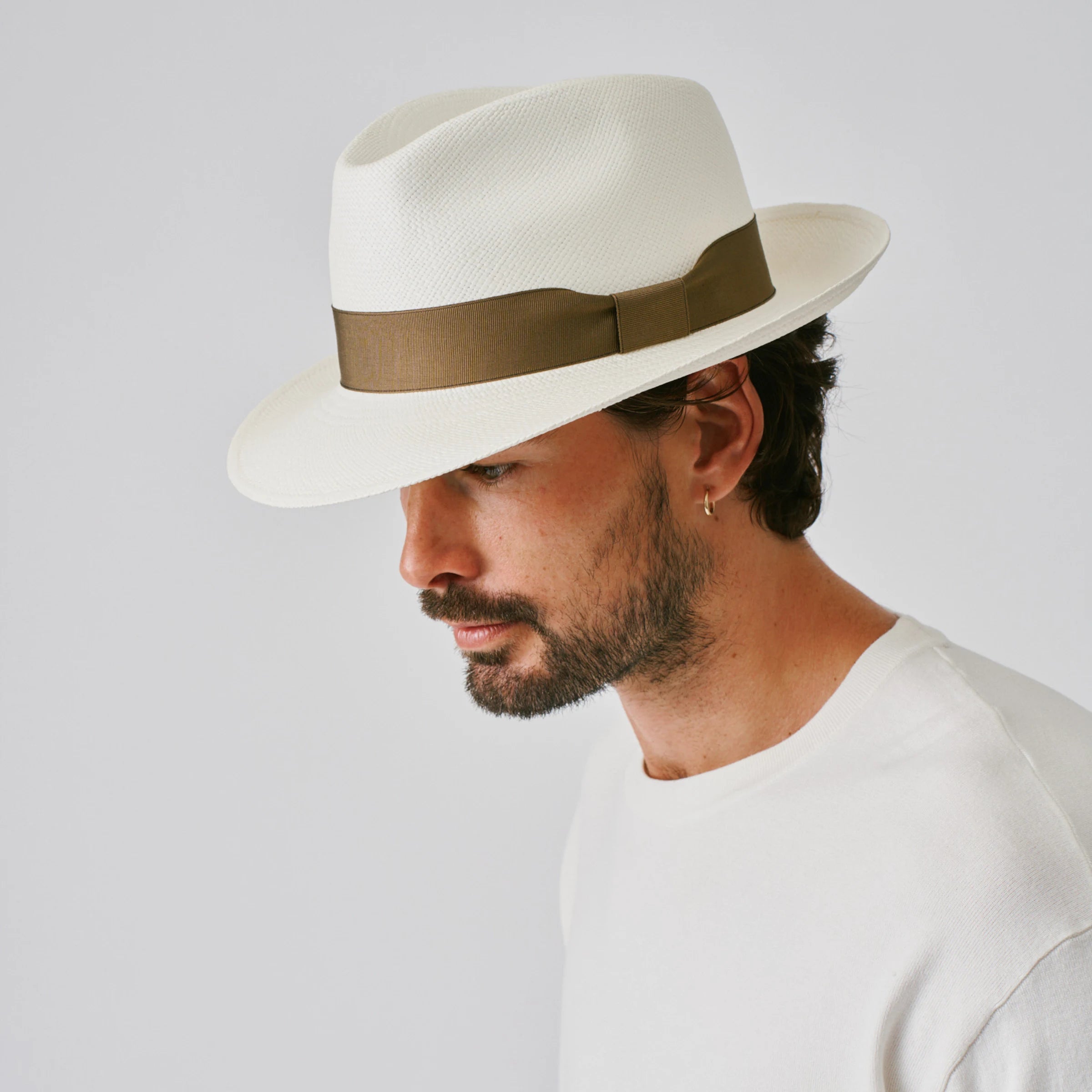 Man wearing a New Fedora Cream / Fawn Panama hat against a plain background.