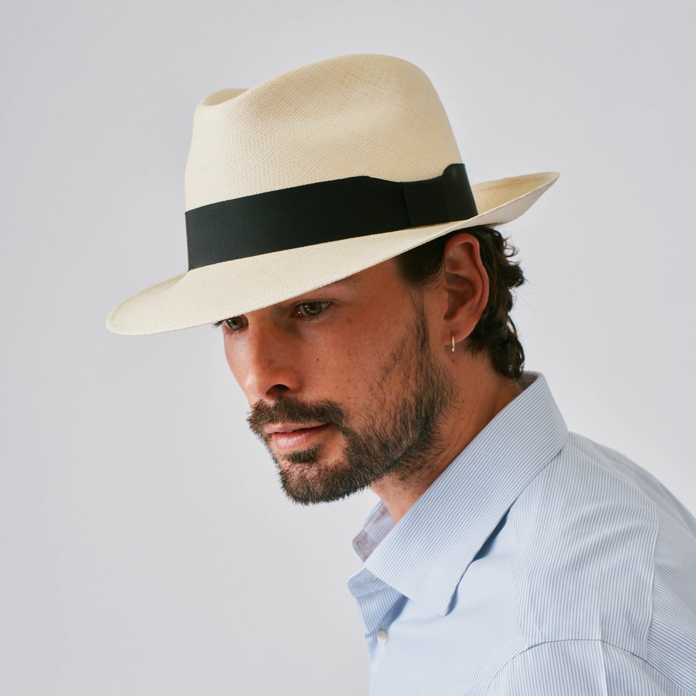 Man wearing a New Fedora Fino Natural / Black Panama hat against a plain background.