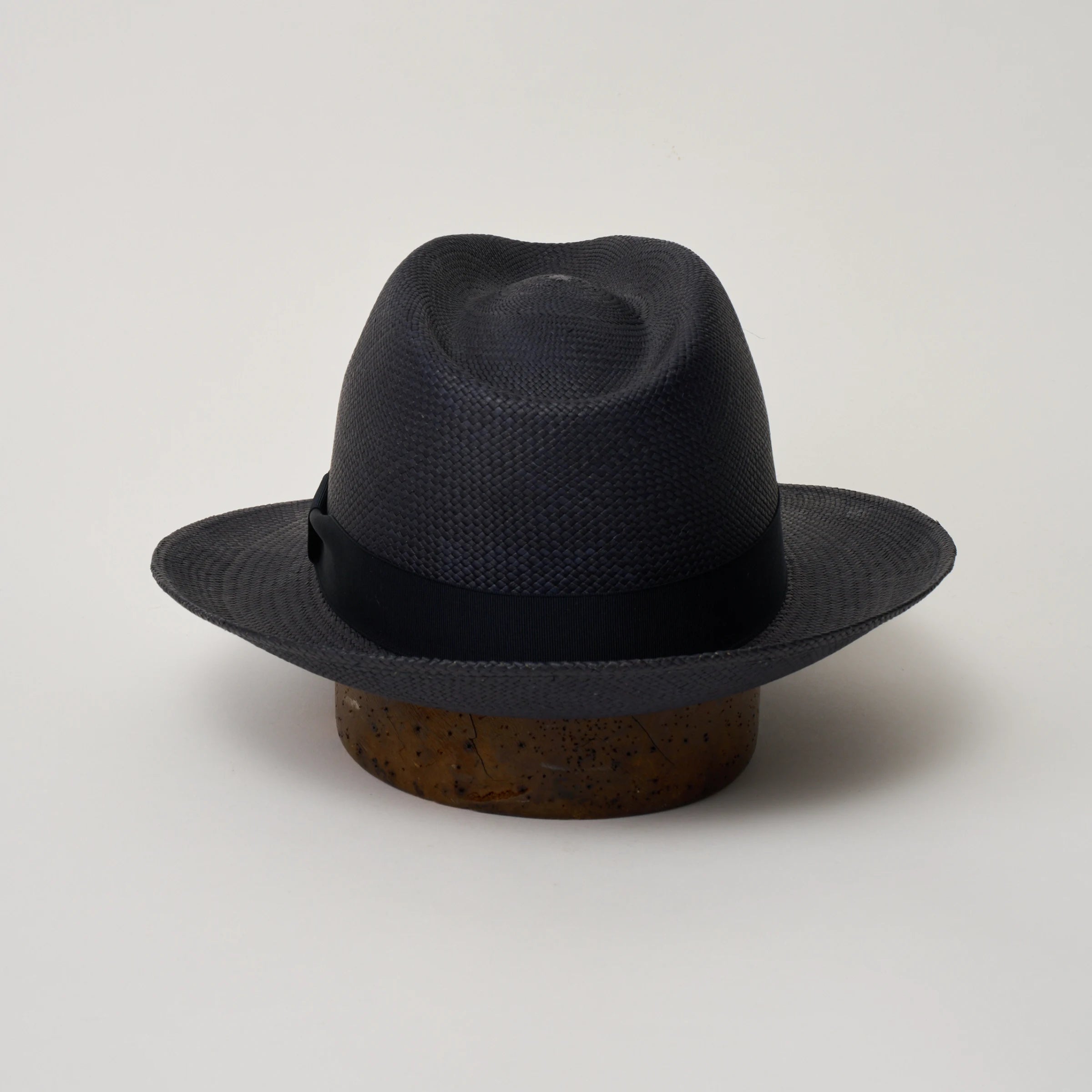 Studio image of the Camilo New Fedora Navy coloured Panama Hat with Marine trim shown from the back, showing snapback brim.