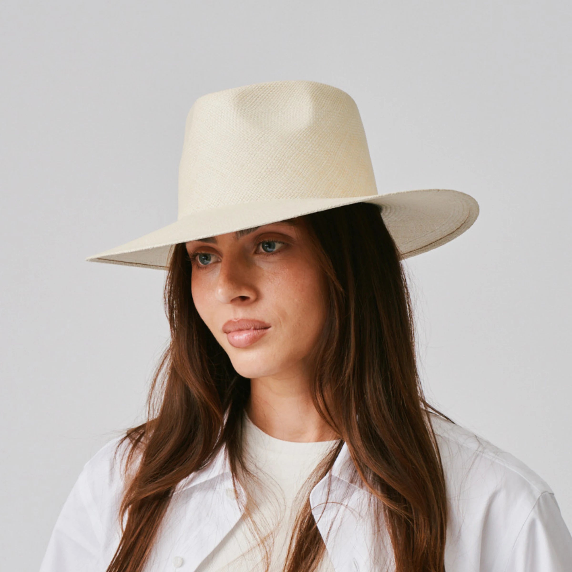 Woman wearing a Country Natural Panama hat against a plain background.
