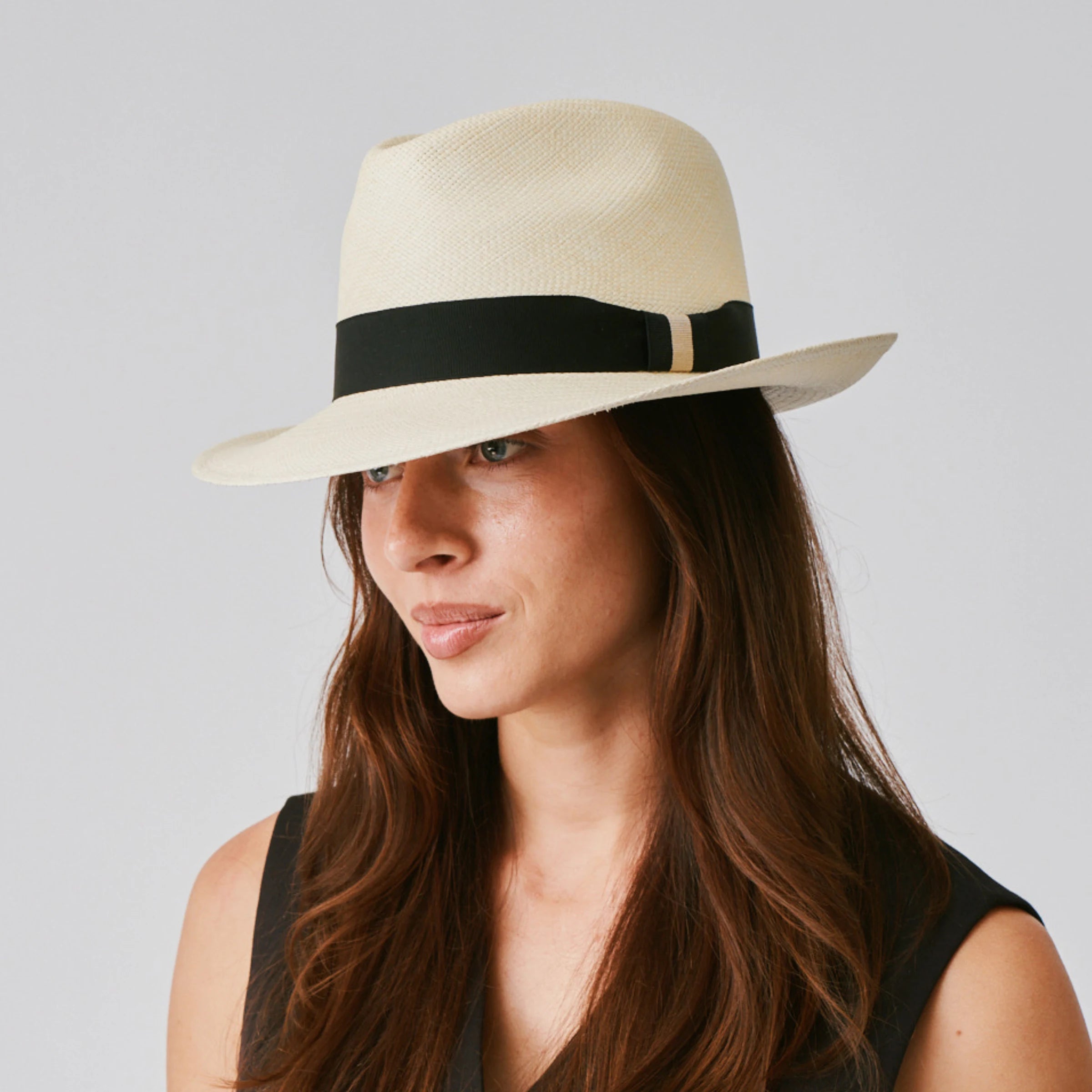 Woman wearing a New Fedora Natural / Black Panama hat against a plain background.